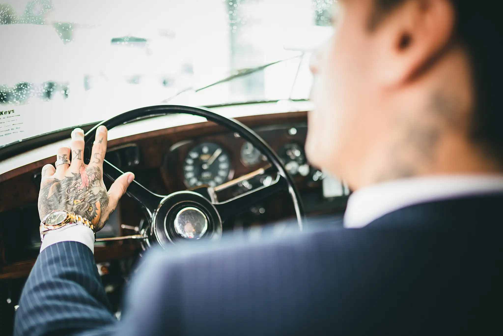 Styled Shoot Hollywood Regency Wedding Inspiration Atlanta Photographers Wedding Details: the groom's hand on the Rolls-Royce steering wheel, at a Hollywood Regency Wedding styled shoot at the Foxglove in Marietta, GA