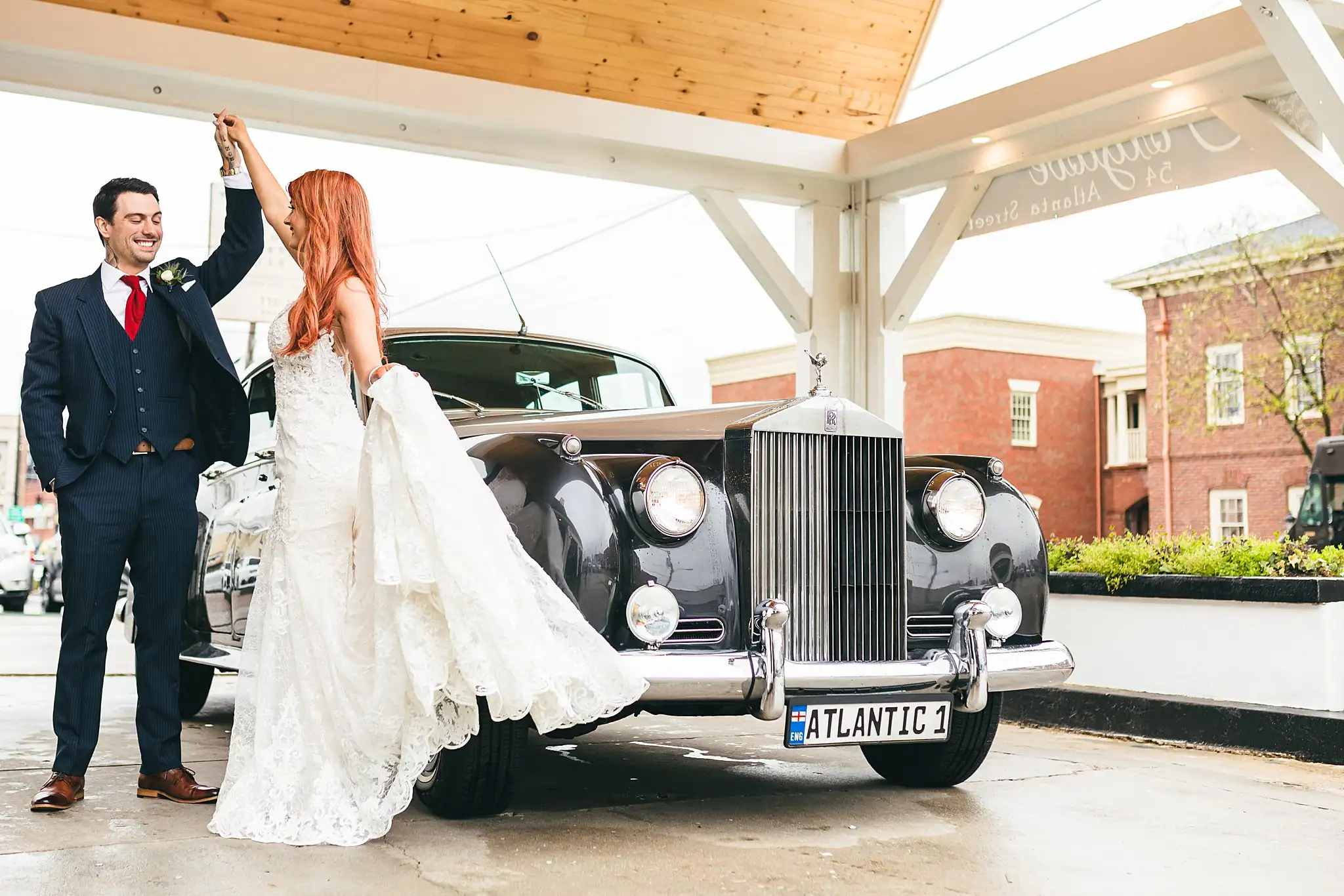 Styled Shoot Hollywood Regency Wedding Inspiration Atlanta Photographers Wedding Formals: the groom turning the bride by the Rolls-Royce, at a Hollywood Regency Wedding styled shoot at the Foxglove in Marietta, GA