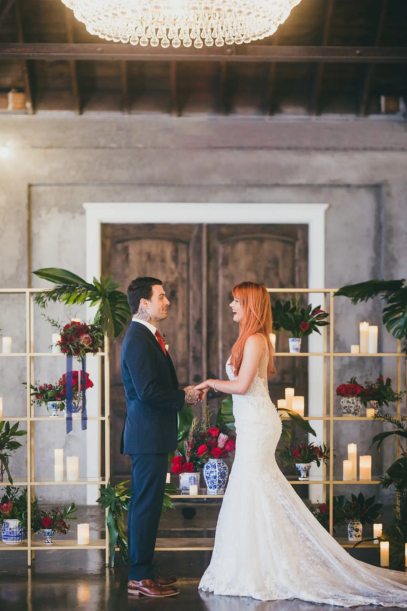 Styled Shoot Hollywood Regency Wedding Inspiration Atlanta Photographers Wedding Ceremony: the couple holding hands under the chandelier, at a Hollywood Regency Wedding styled shoot at the Foxglove in Marietta, GA