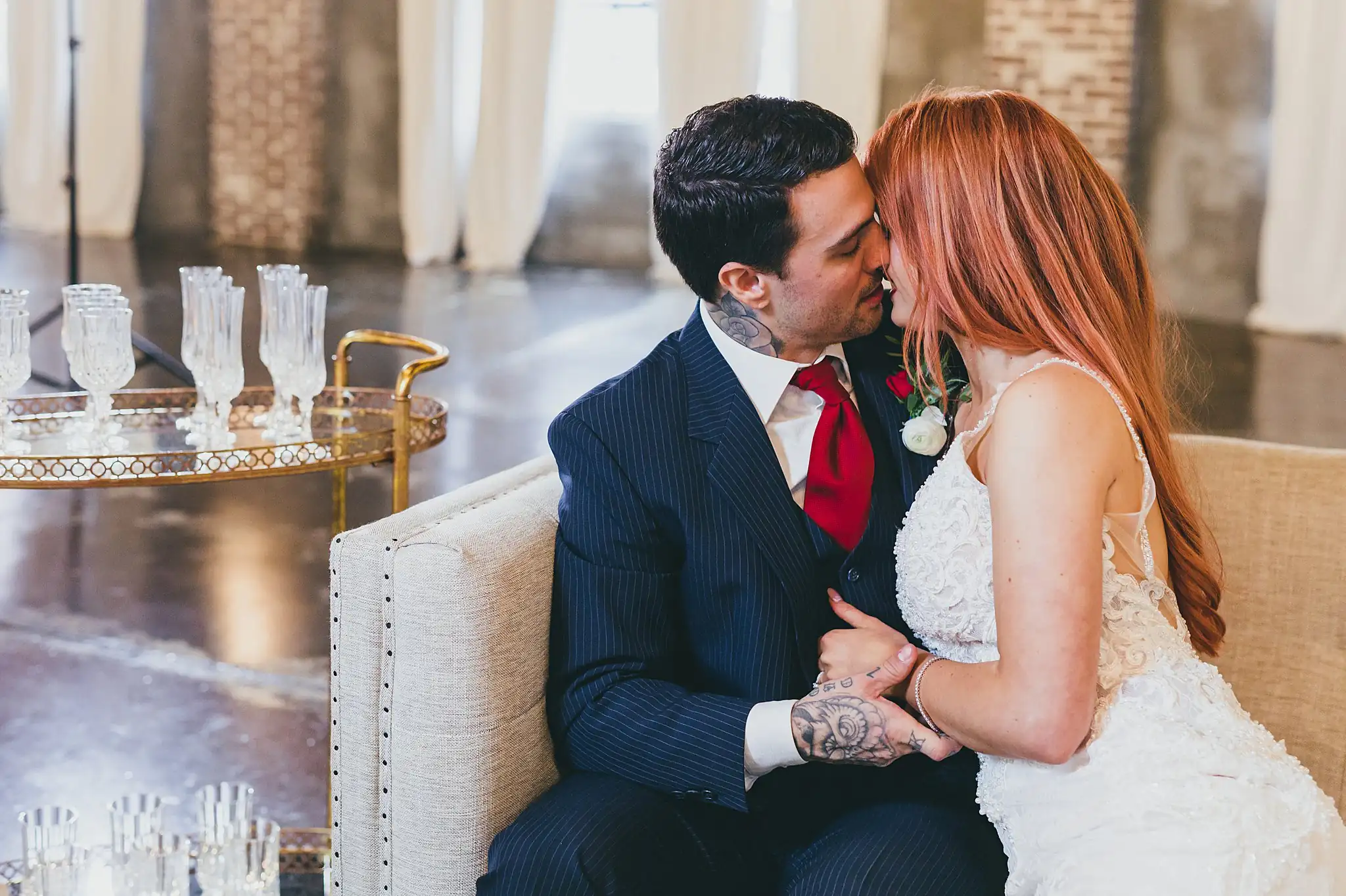 Styled Shoot Hollywood Regency Wedding Inspiration Atlanta Photographers Wedding Formals: the couple sitting close beside the bar cart, at a Hollywood Regency Wedding styled shoot at the Foxglove in Marietta, GA