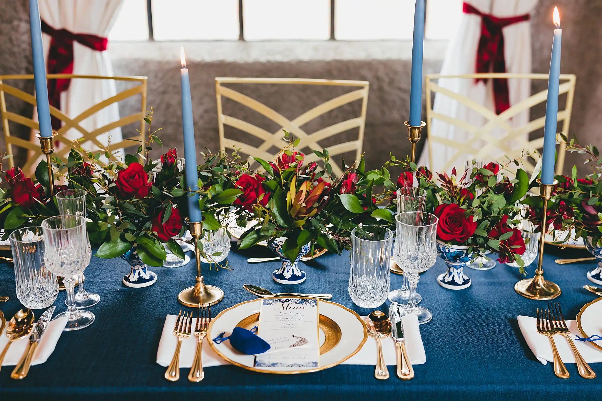Styled Shoot Hollywood Regency Wedding Inspiration Atlanta Photographers Reception Details: a gold charger, navy napkin and blue tapers, at a Hollywood Regency Wedding styled shoot at the Foxglove in Marietta, GA