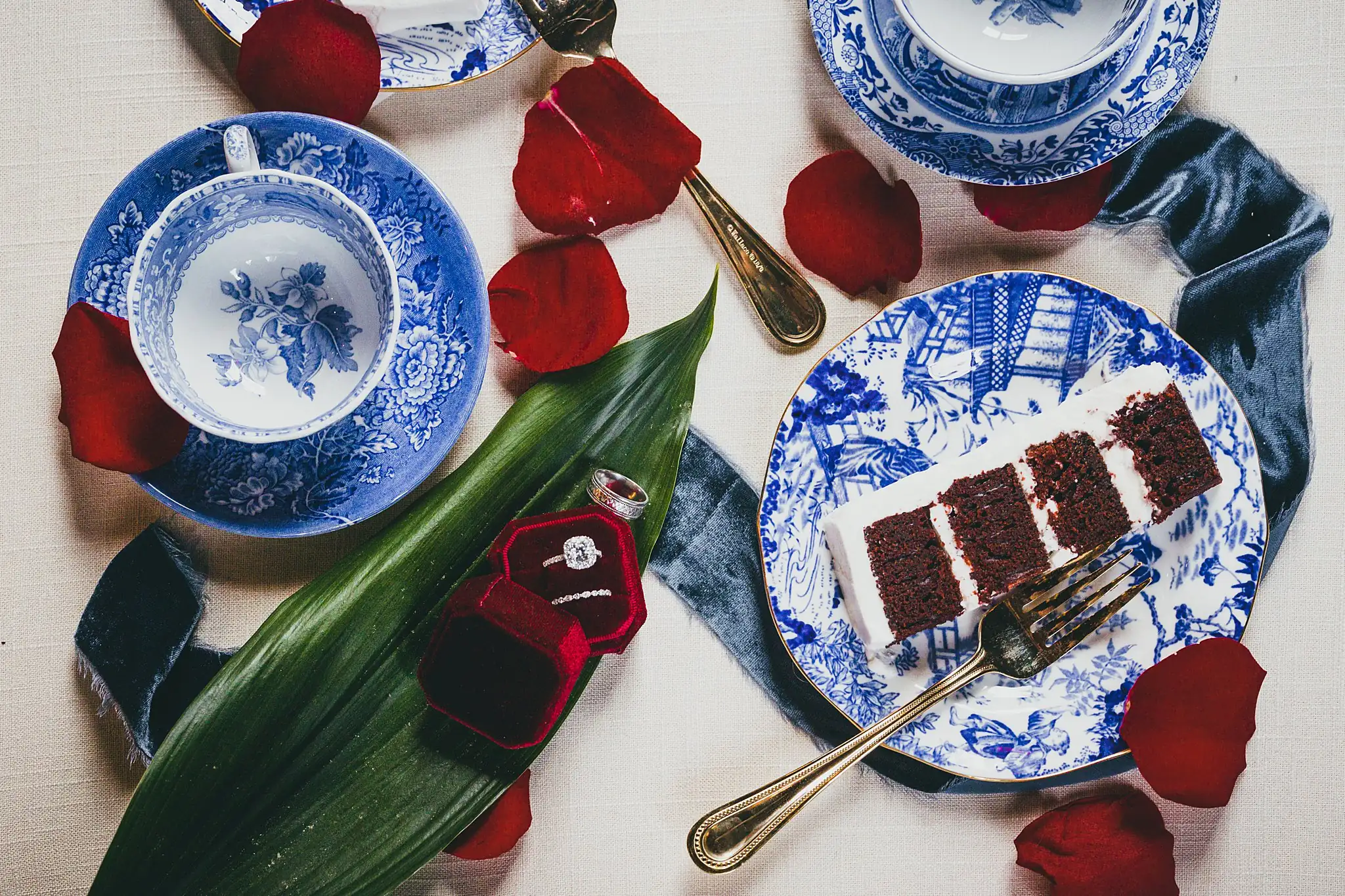 Styled Shoot Hollywood Regency Wedding Inspiration Atlanta Photographers Wedding Cake Details: the cake slice on china with the red ring box, at a Hollywood Regency Wedding styled shoot at the Foxglove in Marietta, GA