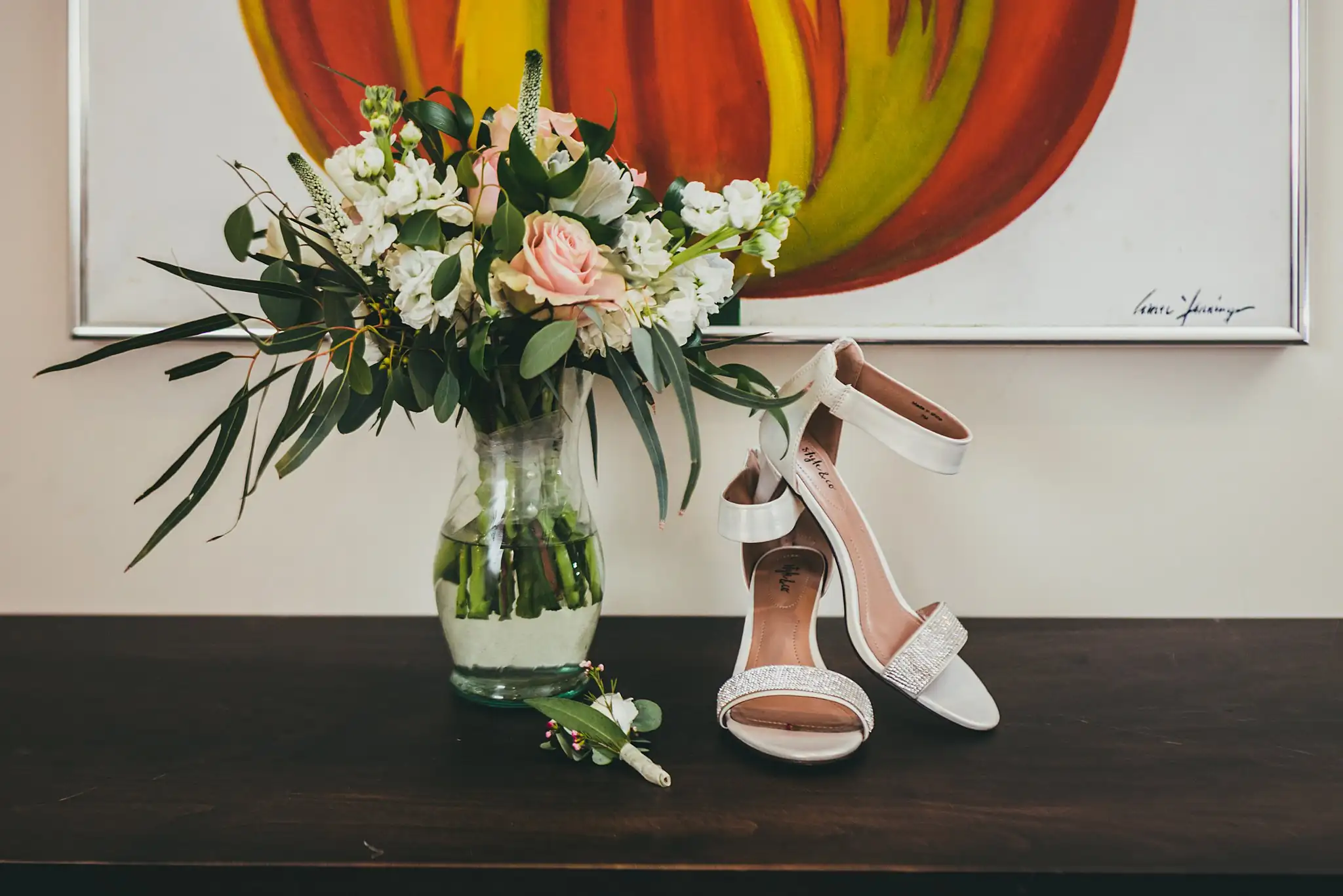 Wedding Details: the bouquet and heels beneath a tulip painting, at a wedding at the Atlanta Botanical Garden in Atlanta, GA