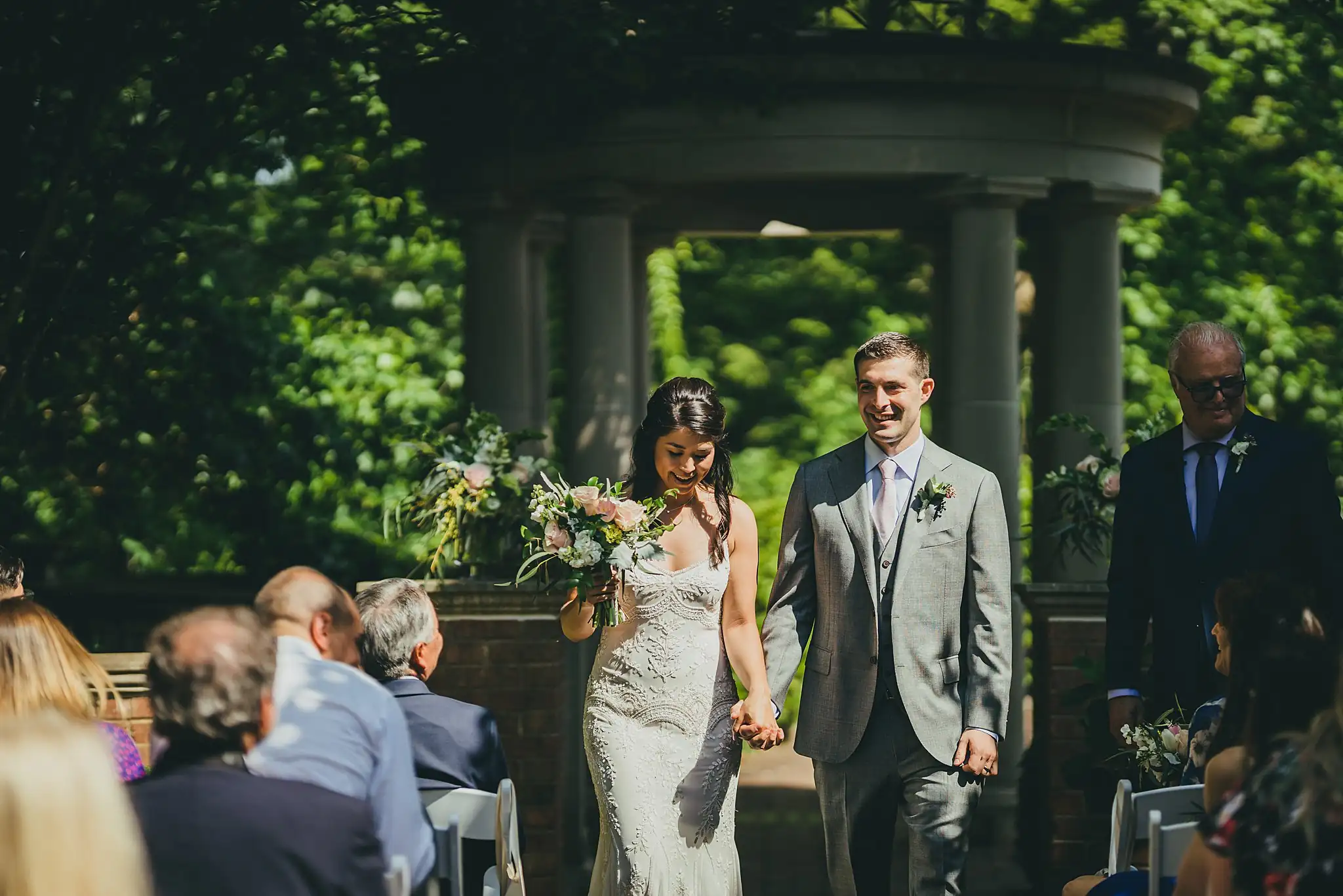 Recessional: the couple coming back down the aisle, at their wedding at the Atlanta Botanical Garden in Atlanta, GA