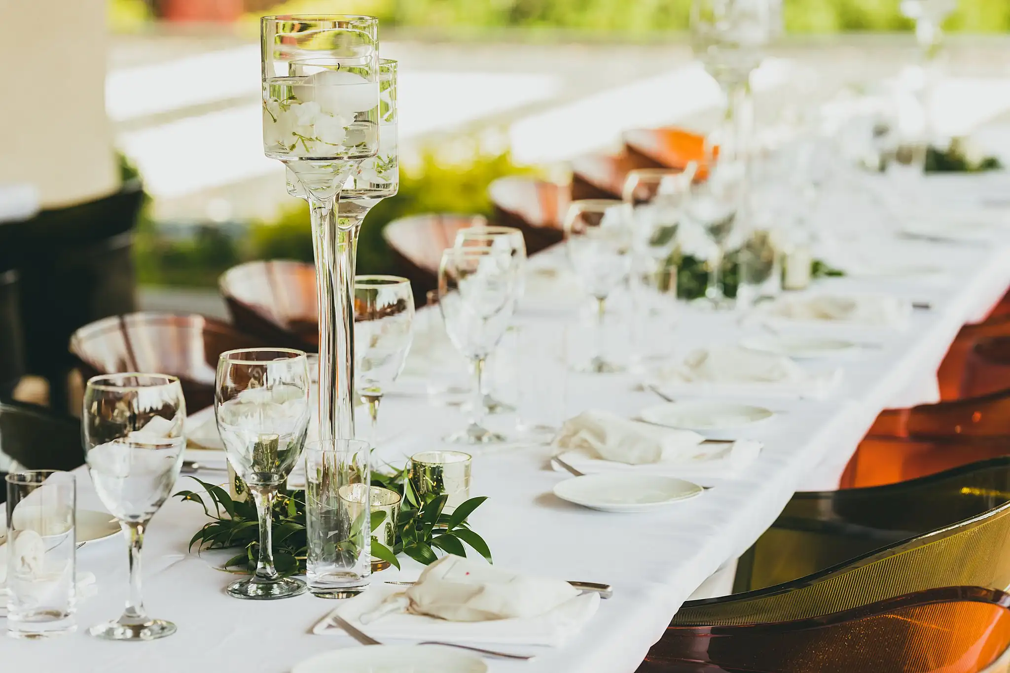 Reception Details: the long table set with candles and greenery, at their wedding at the Atlanta Botanical Garden in Atlanta, GA