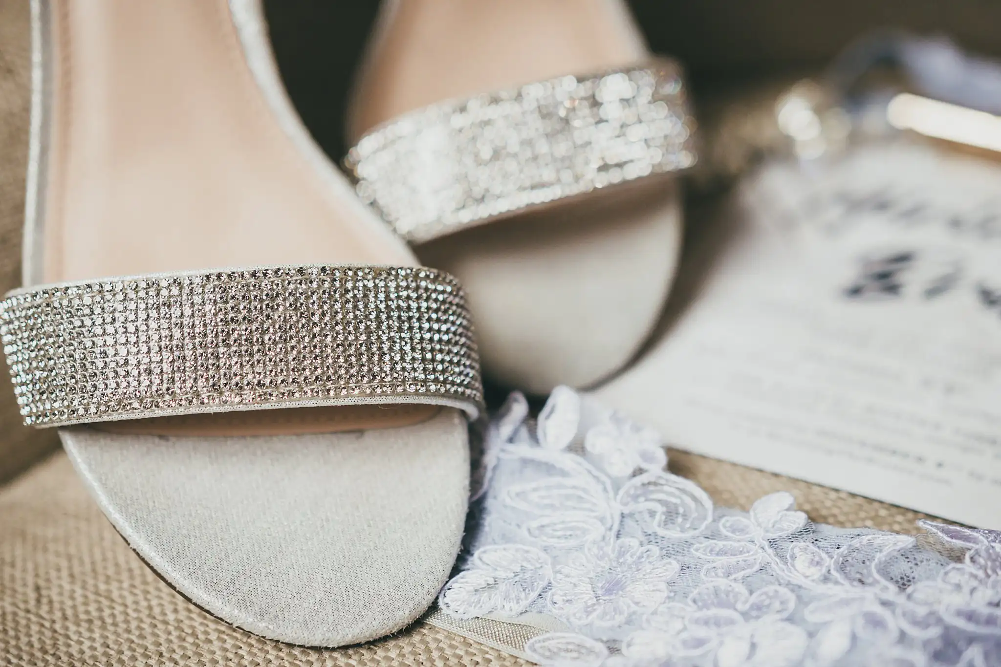 Barn at Harper Pines Wedding Thomaston, GA Atlanta Wedding Photographers Wedding Details: a close look at the bride's rhinestone shoes on lace, at a wedding at the Barn at Harper Pines in Thomaston, GA