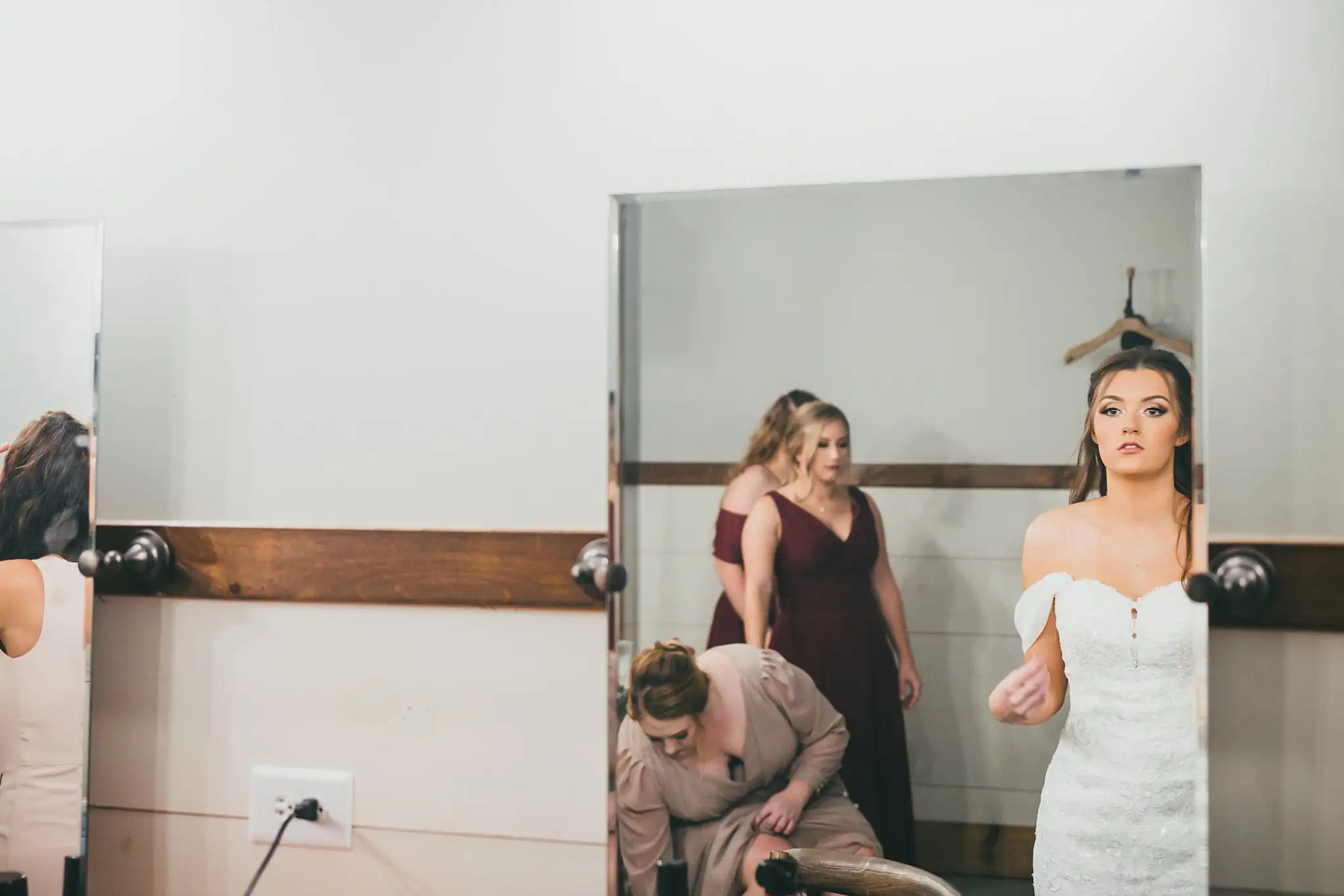 Barn at Harper Pines Wedding Thomaston, GA Atlanta Wedding Photographers Getting Ready: bridesmaids helping the bride into her gown at the mirror, before their wedding at the Barn at Harper Pines in Thomaston, GA