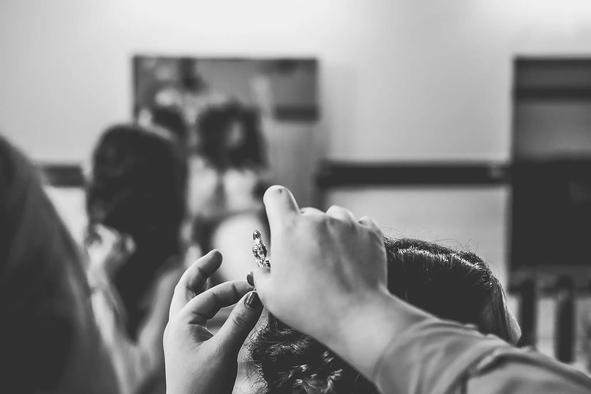 Barn at Harper Pines Wedding Thomaston, GA Atlanta Wedding Photographers Getting Ready: fastening the bride's earring, in black and white, before their wedding at the Barn at Harper Pines in Thomaston, GA