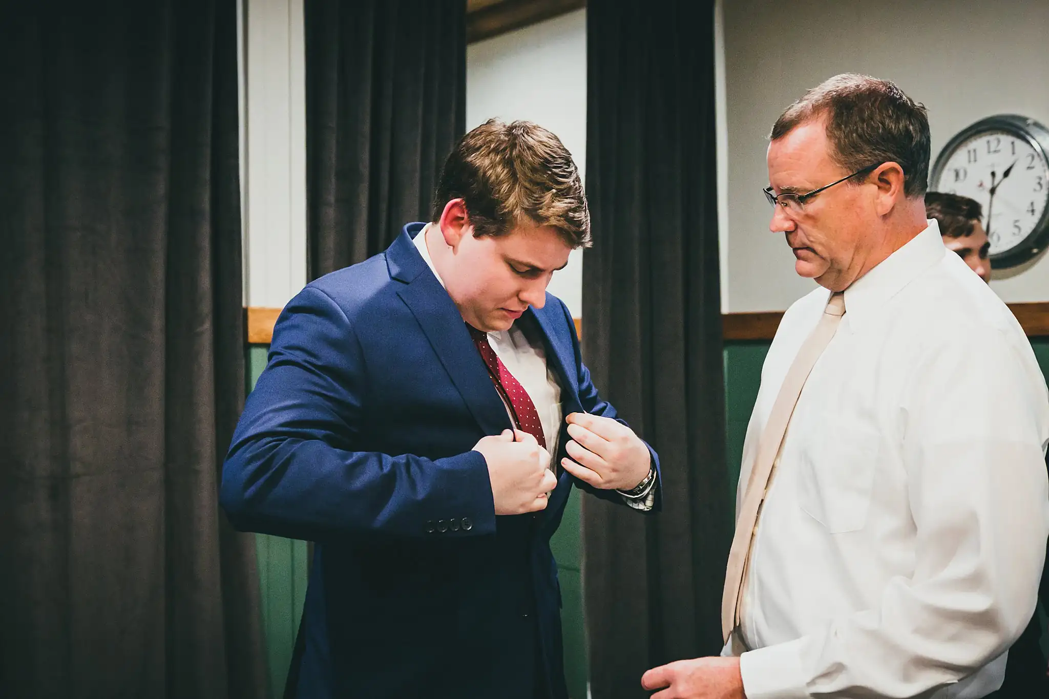 Barn at Harper Pines Wedding Thomaston, GA Atlanta Wedding Photographers Getting Ready: the groom's father pinning his boutonniere, before their wedding at the Barn at Harper Pines in Thomaston, GA