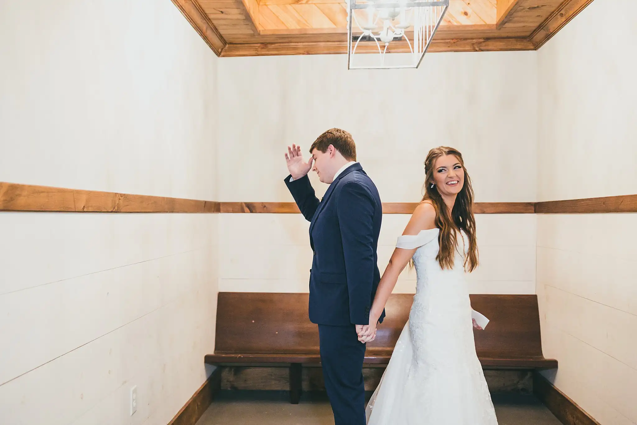 Barn at Harper Pines Wedding Thomaston, GA Atlanta Wedding Photographers First Look: the groom waiting back to back with the bride, before their wedding at the Barn at Harper Pines in Thomaston, GA
