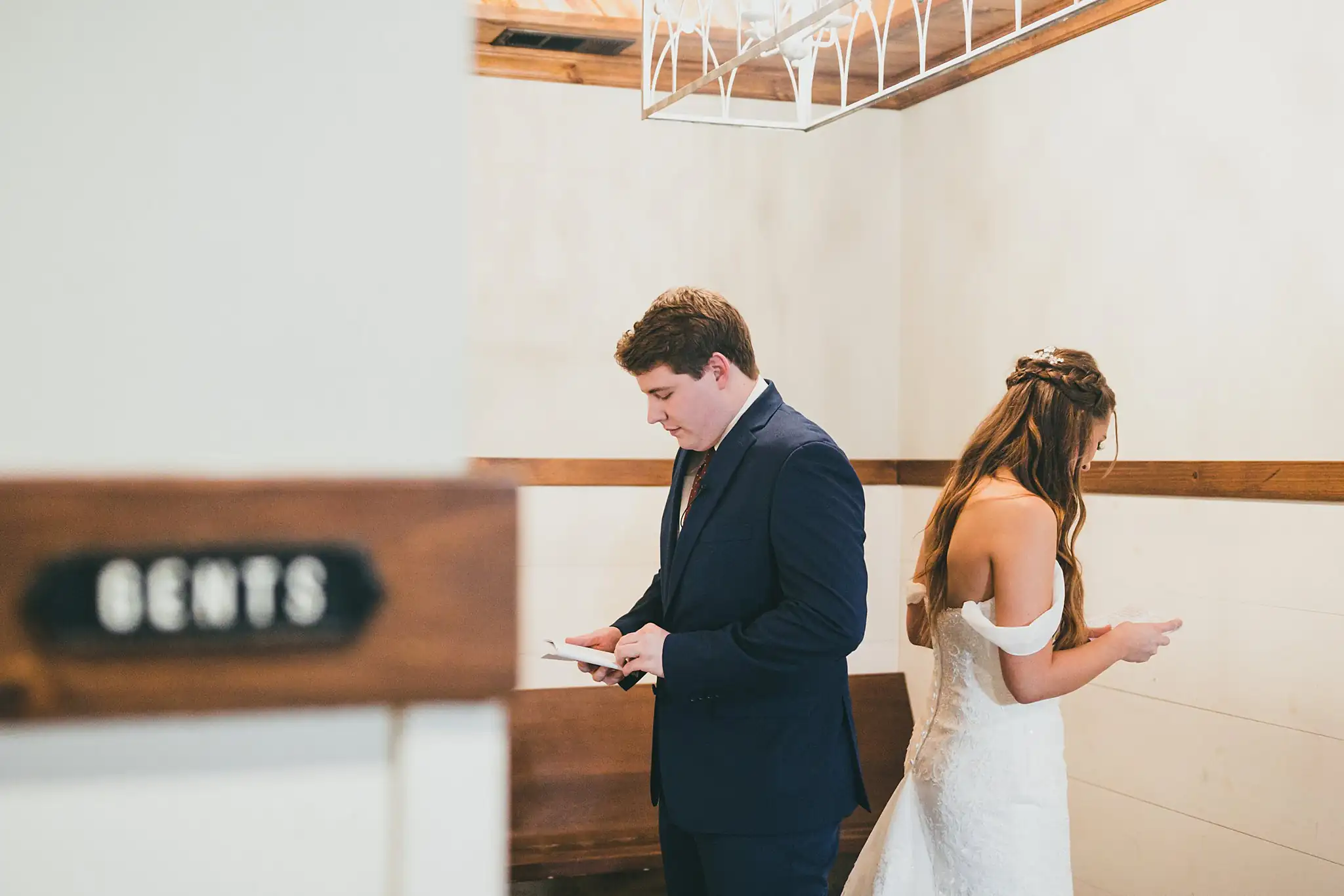 Barn at Harper Pines Wedding Thomaston, GA Atlanta Wedding Photographers First Look: the groom reading his letter with the bride behind him, before their wedding at the Barn at Harper Pines in Thomaston, GA