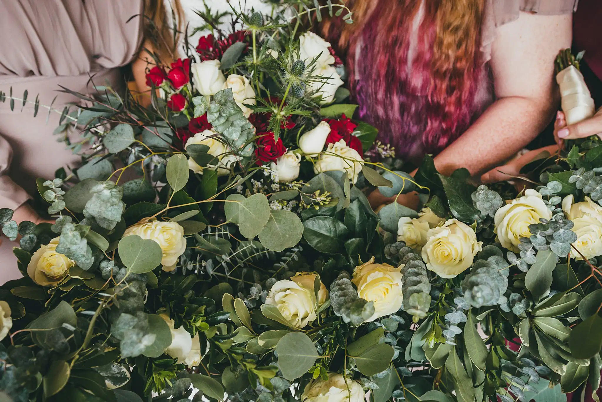 Barn at Harper Pines Wedding Thomaston, GA Atlanta Wedding Photographers Wedding Florals: red and white roses with eucalyptus in the bridal bouquet, at a wedding at the Barn at Harper Pines in Thomaston, GA