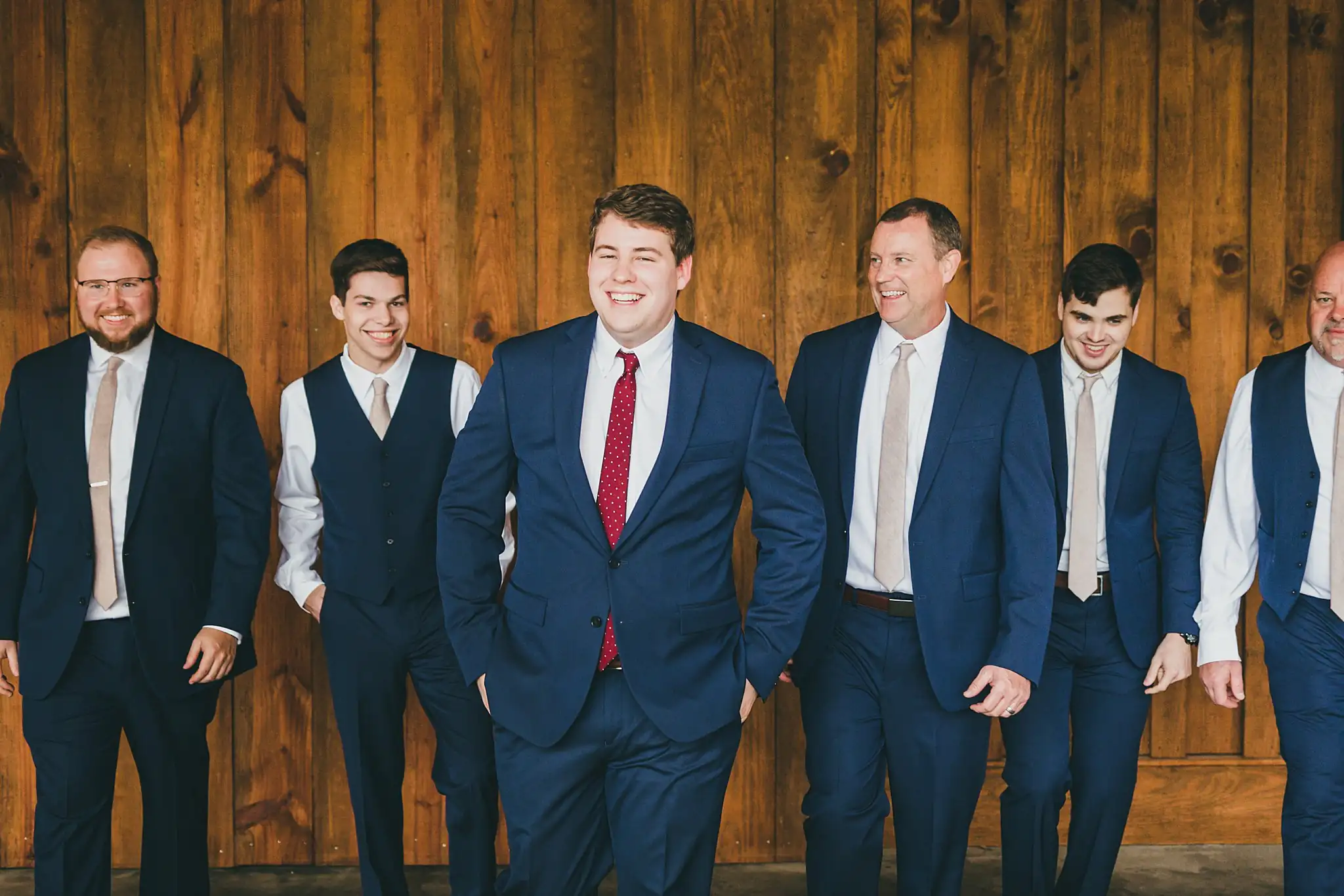 Barn at Harper Pines Wedding Thomaston, GA Atlanta Wedding Photographers Wedding Party: the groom walking with his groomsmen, at their wedding at the Barn at Harper Pines in Thomaston, GA