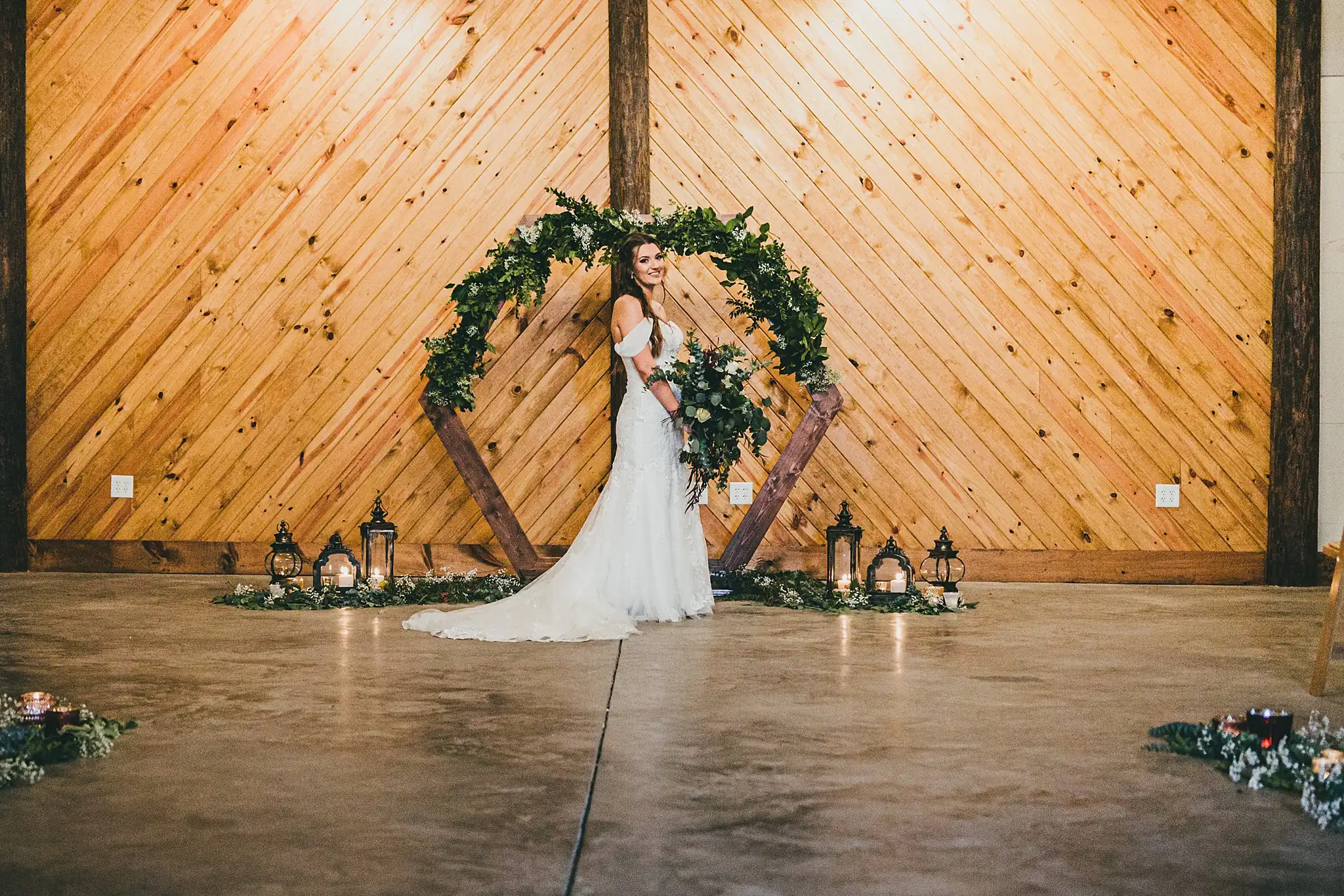 Barn at Harper Pines Wedding Thomaston, GA Atlanta Wedding Photographers Bridal Portraits: the bride beneath the circular greenery arch, at their wedding at the Barn at Harper Pines in Thomaston, GA
