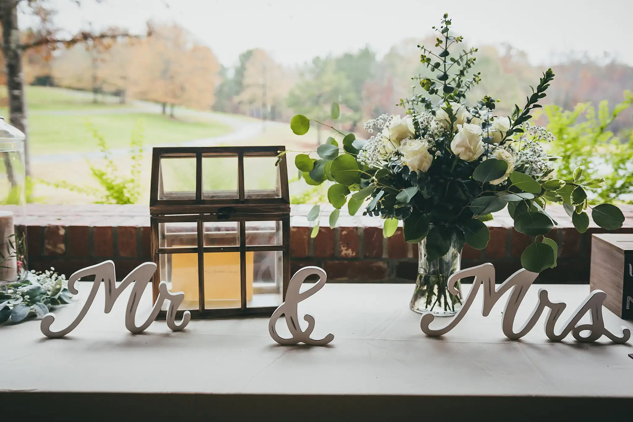 Barn at Harper Pines Wedding Thomaston, GA Atlanta Wedding Photographers Reception Details: the Mr and Mrs sign with the card box and florals, at a wedding at the Barn at Harper Pines in Thomaston, GA