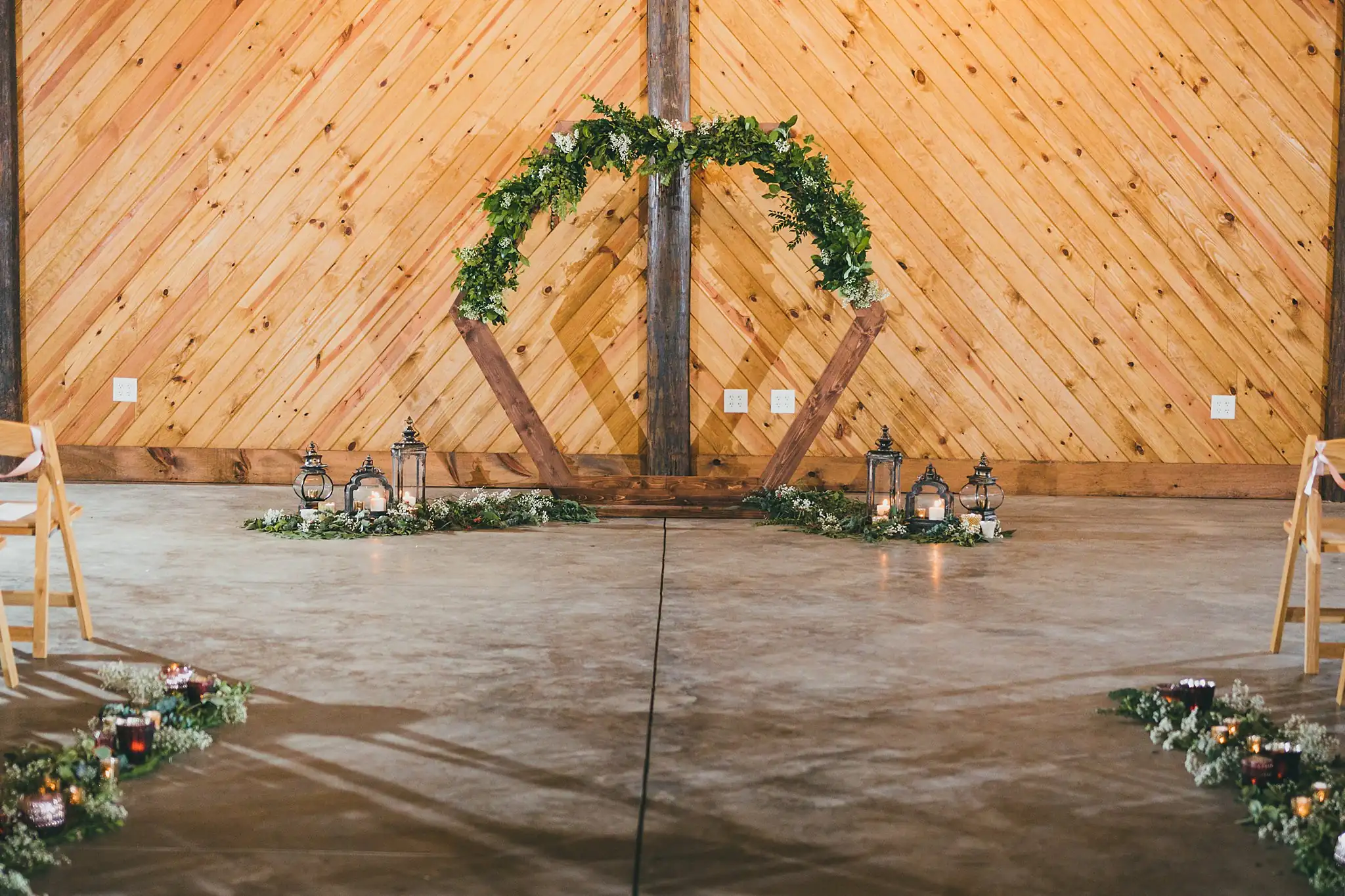 Barn at Harper Pines Wedding Thomaston, GA Atlanta Wedding Photographers Wedding Ceremony: the circular greenery arch and lanterns before the ceremony, at their wedding at the Barn at Harper Pines in Thomaston, GA