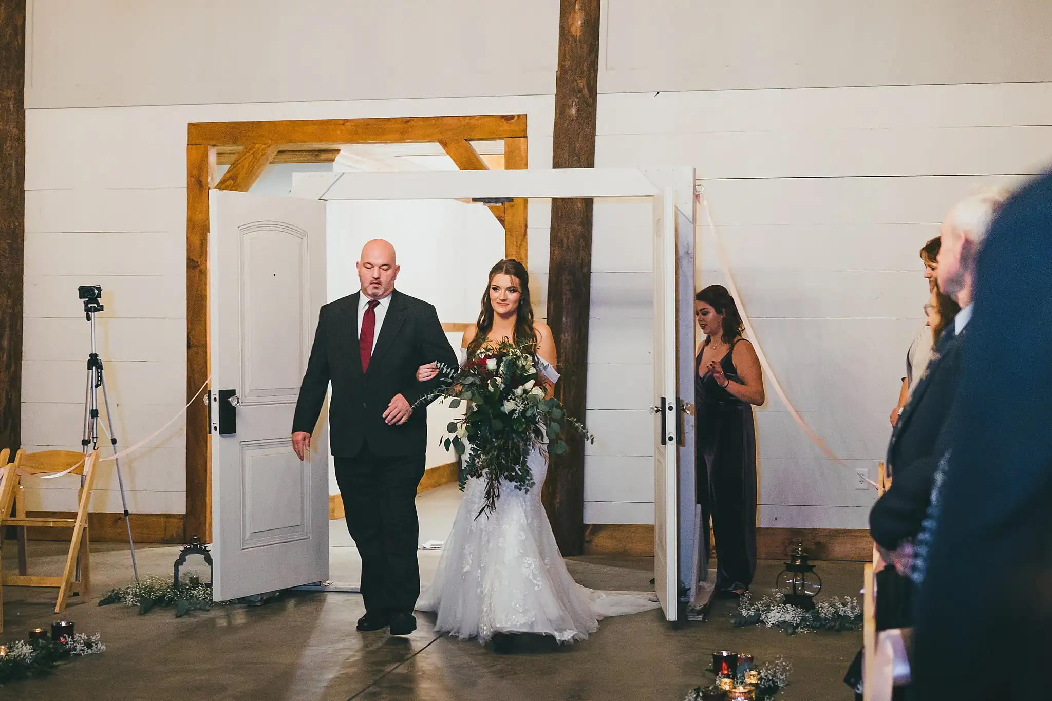 Barn at Harper Pines Wedding Thomaston, GA Atlanta Wedding Photographers Processional: the bride walking in on her father's arm, at their wedding at the Barn at Harper Pines in Thomaston, GA