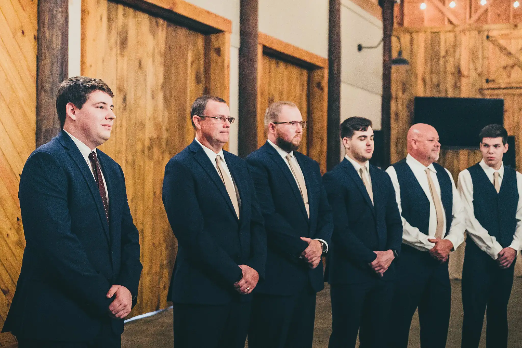 Barn at Harper Pines Wedding Thomaston, GA Atlanta Wedding Photographers Wedding Ceremony: the groom and groomsmen watching the bride come in, at their wedding at the Barn at Harper Pines in Thomaston, GA