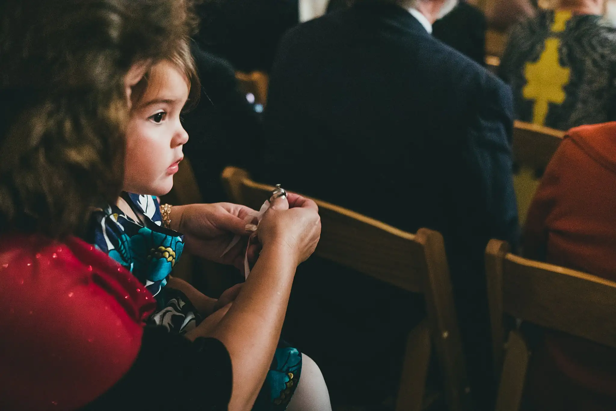 Barn at Harper Pines Wedding Thomaston, GA Atlanta Wedding Photographers Wedding Ceremony: a young guest watching from the chairs, at their wedding at the Barn at Harper Pines in Thomaston, GA