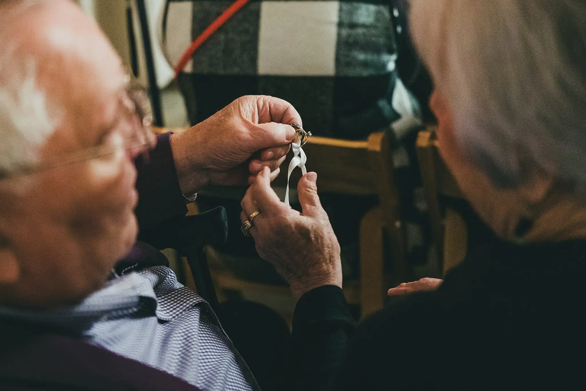 Barn at Harper Pines Wedding Thomaston, GA Atlanta Wedding Photographers Wedding Ceremony: a grandparent holding the wedding bands, at their wedding at the Barn at Harper Pines in Thomaston, GA