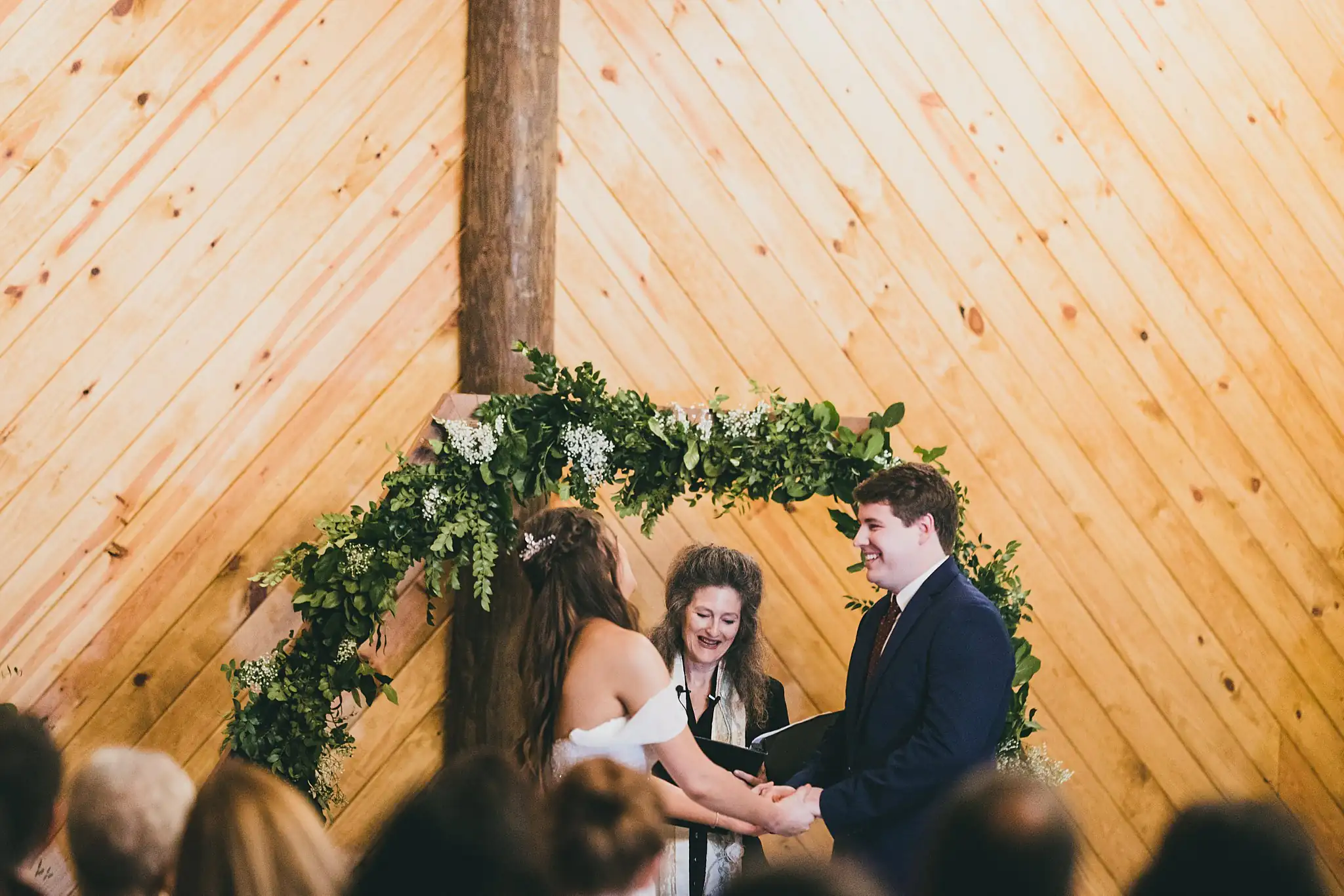 Barn at Harper Pines Wedding Thomaston, GA Atlanta Wedding Photographers Wedding Ceremony: the couple holding hands as they say their vows, at their wedding at the Barn at Harper Pines in Thomaston, GA