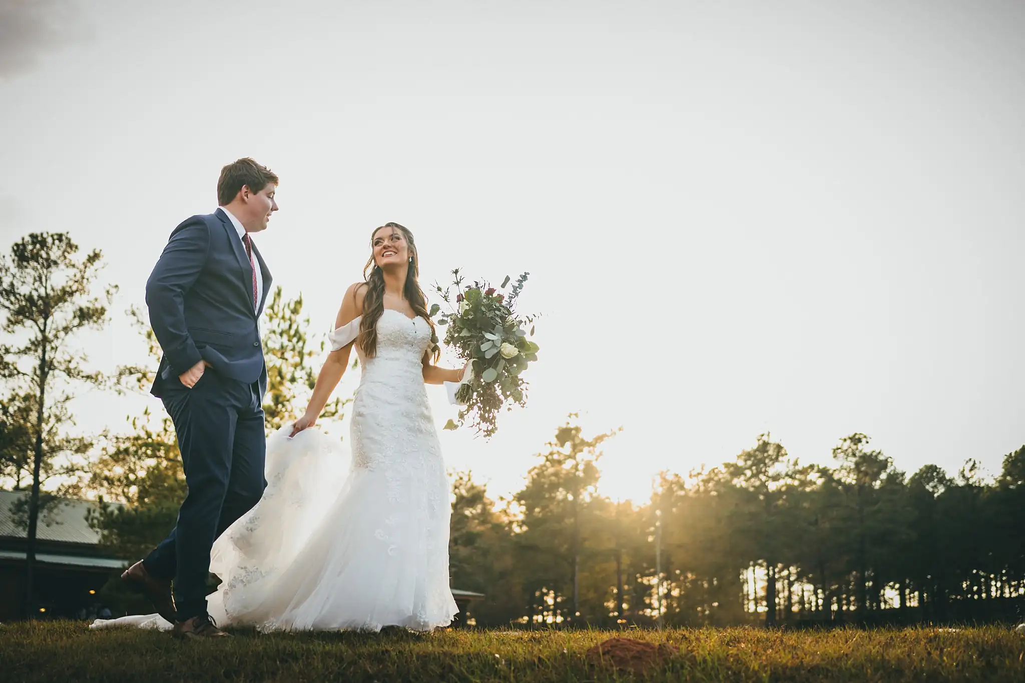 Barn at Harper Pines Wedding Thomaston, GA Atlanta Wedding Photographers Wedding Formals: the couple in the field at sunset, at their wedding at the Barn at Harper Pines in Thomaston, GA
