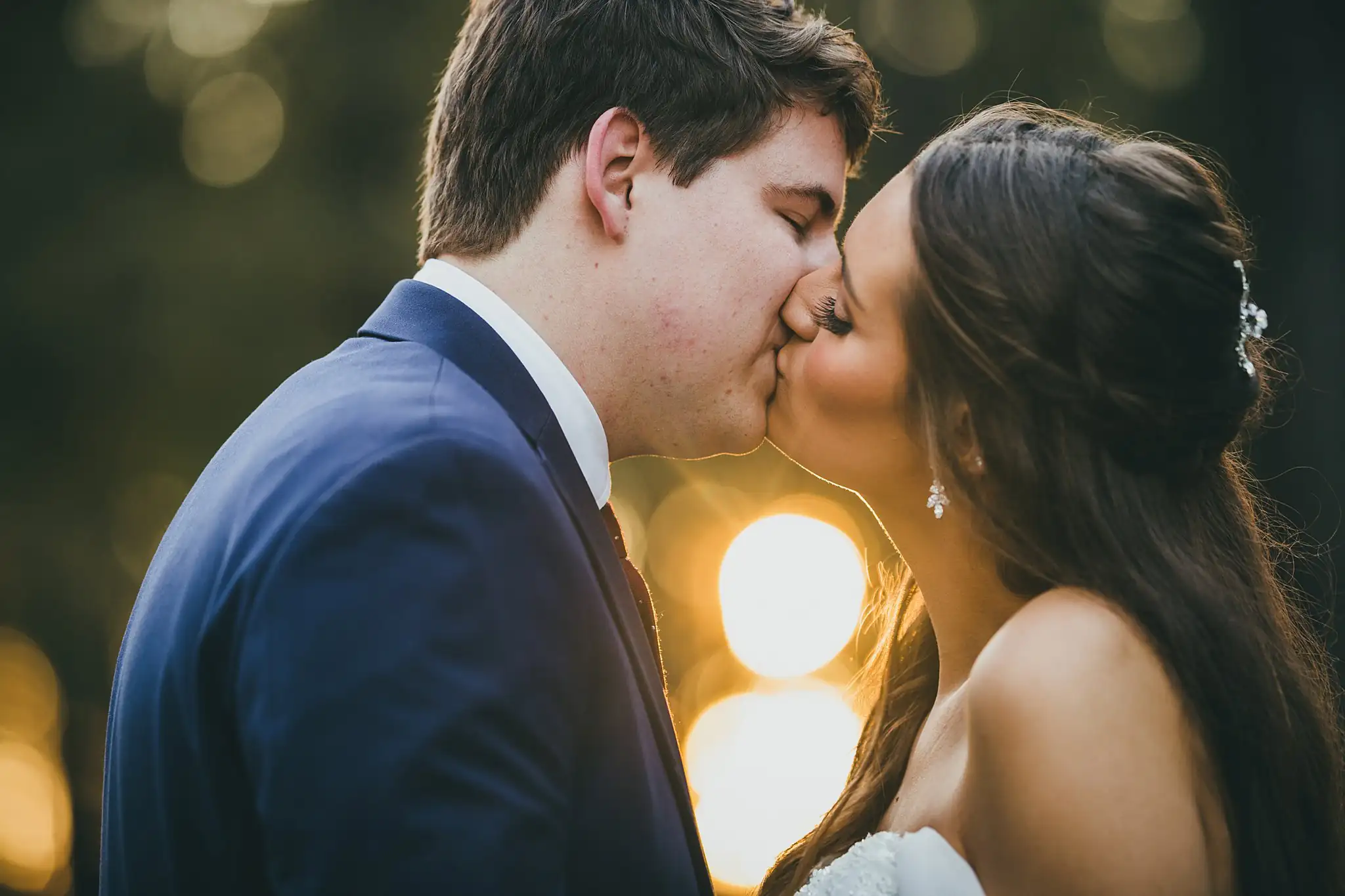 Barn at Harper Pines Wedding Thomaston, GA Atlanta Wedding Photographers Wedding Formals: the couple kissing at golden hour, at their wedding at the Barn at Harper Pines in Thomaston, GA