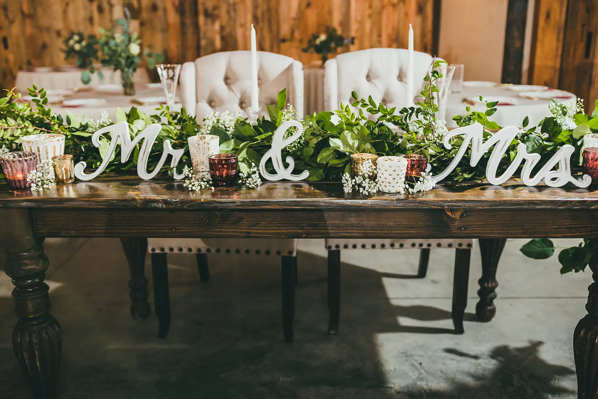 Barn at Harper Pines Wedding Thomaston, GA Atlanta Wedding Photographers Reception Details: the sweetheart table with its Mr and Mrs sign, at a wedding at the Barn at Harper Pines in Thomaston, GA