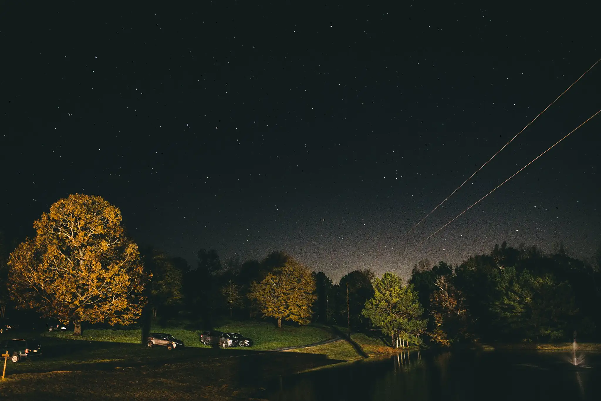 Barn at Harper Pines Wedding Thomaston, GA Atlanta Wedding Photographers Reception Details: the lake and autumn treeline after dark, at a wedding at the Barn at Harper Pines in Thomaston, GA