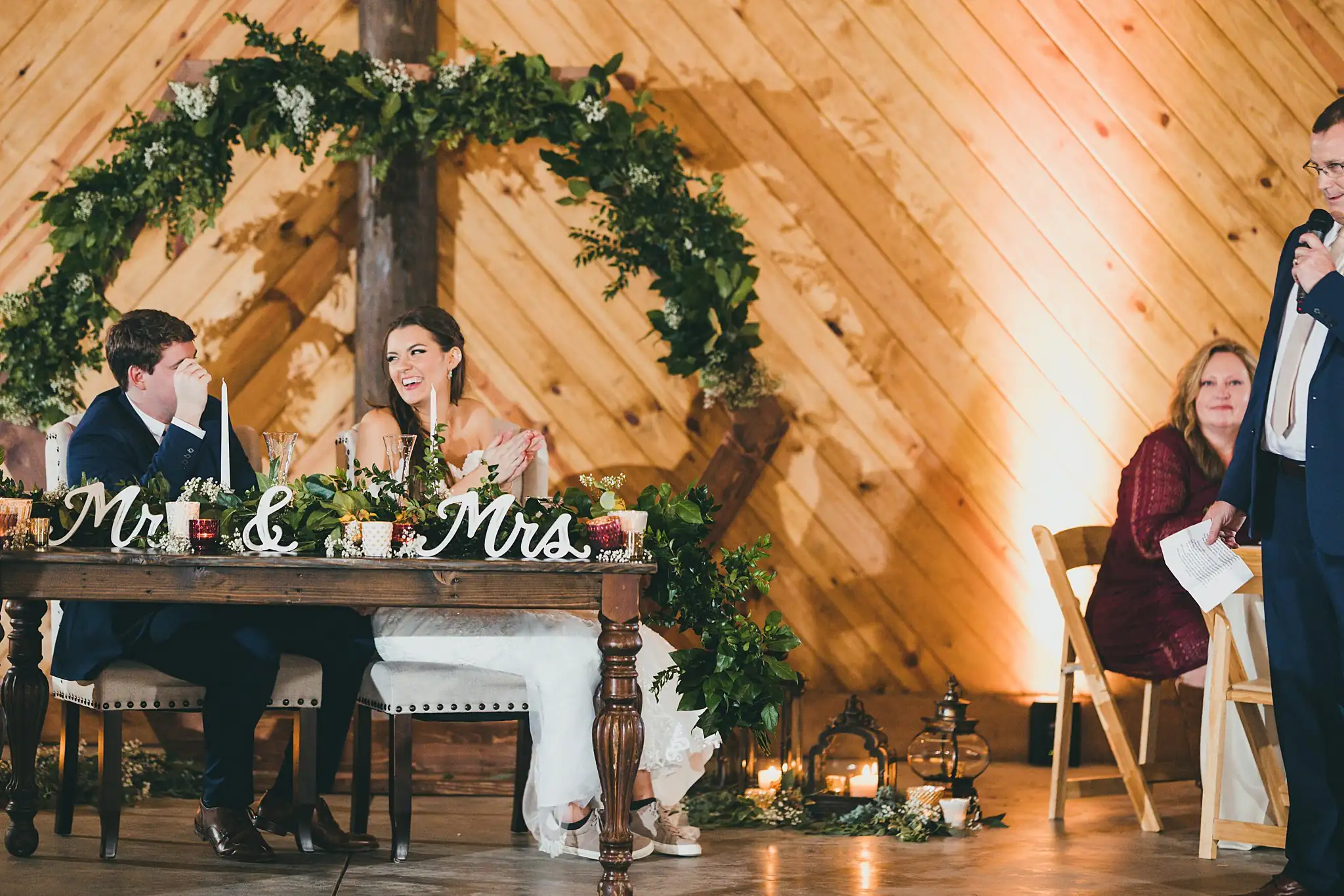 Barn at Harper Pines Wedding Thomaston, GA Atlanta Wedding Photographers Wedding Reception: the couple listening to a toast, at their wedding at the Barn at Harper Pines in Thomaston, GA