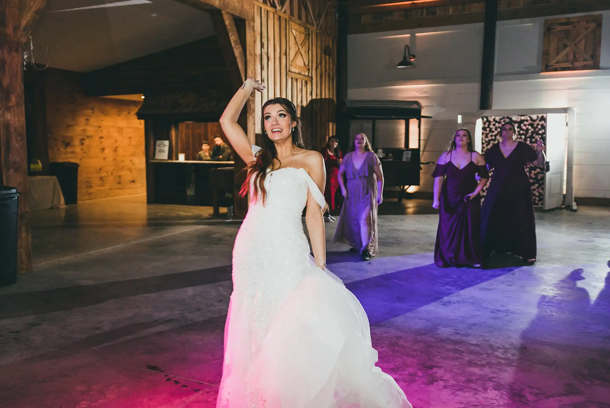Barn at Harper Pines Wedding Thomaston, GA Atlanta Wedding Photographers Bouquet Toss: the bride turning to throw her bouquet, at their wedding at the Barn at Harper Pines in Thomaston, GA