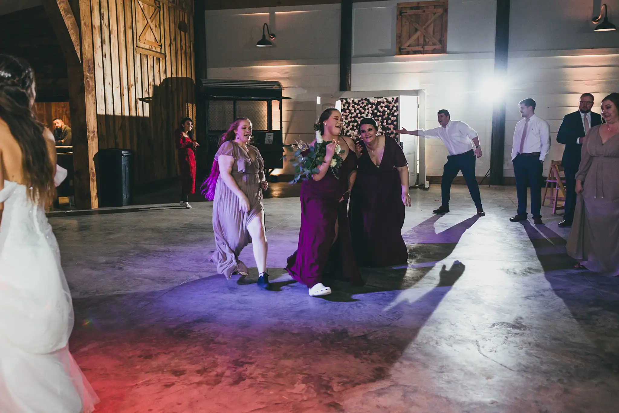 Barn at Harper Pines Wedding Thomaston, GA Atlanta Wedding Photographers Bouquet Toss: the guests reaching for the bouquet, at their wedding at the Barn at Harper Pines in Thomaston, GA