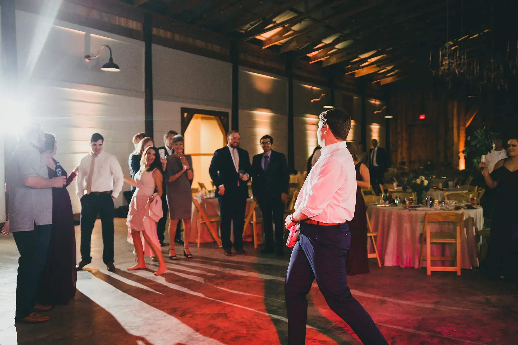 Barn at Harper Pines Wedding Thomaston, GA Atlanta Wedding Photographers Garter Toss: the men waiting for the garter, at their wedding at the Barn at Harper Pines in Thomaston, GA