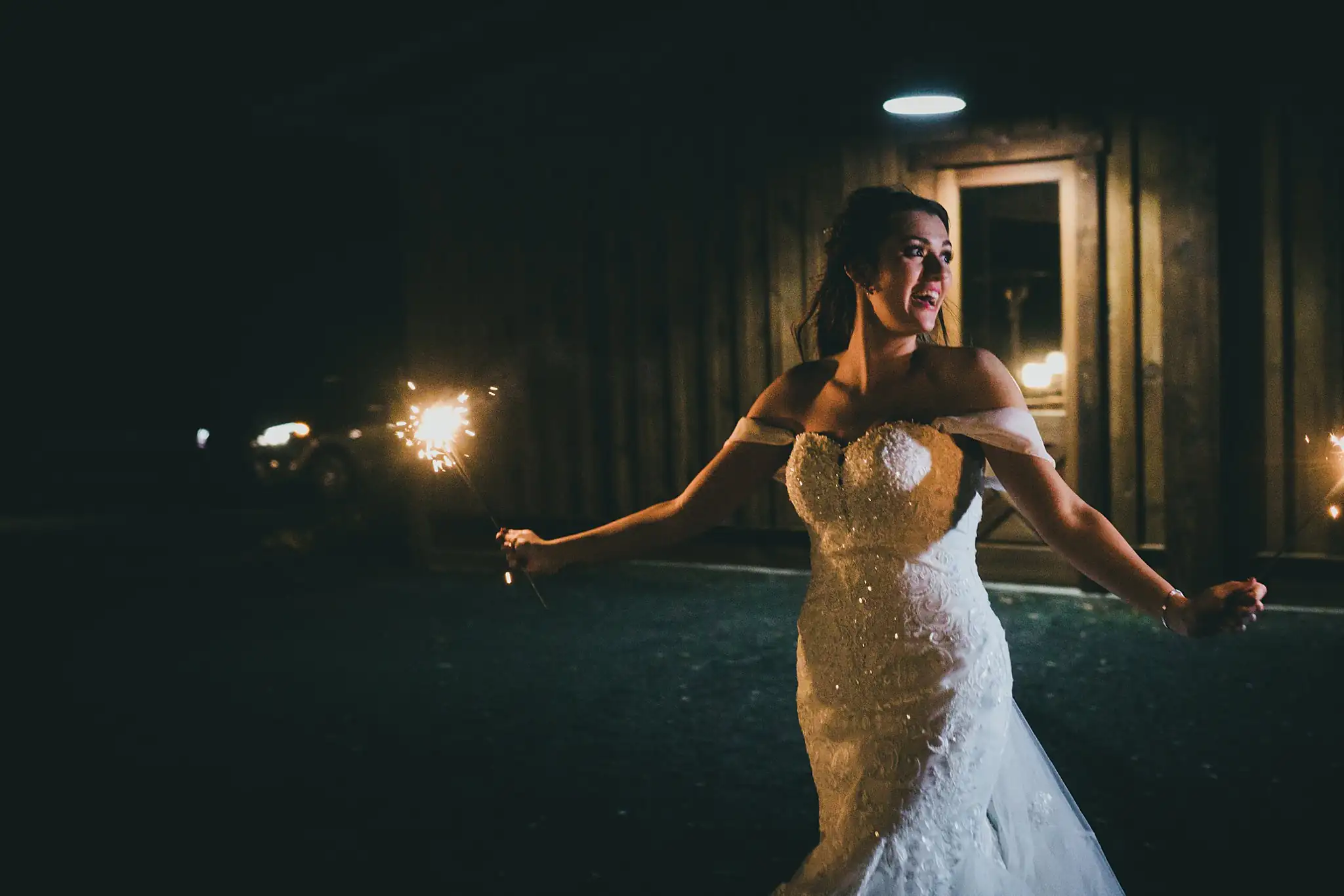 Barn at Harper Pines Wedding Thomaston, GA Atlanta Wedding Photographers Bridal Portraits: the bride with sparklers after dark, at their wedding at the Barn at Harper Pines in Thomaston, GA