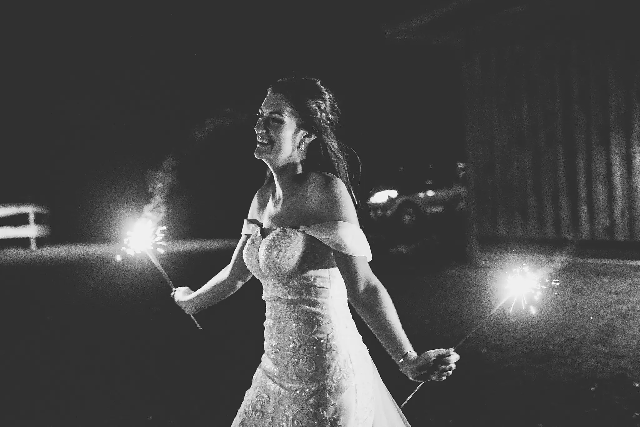 Barn at Harper Pines Wedding Thomaston, GA Atlanta Wedding Photographers Bridal Portraits: the bride with sparklers, in black and white, at their wedding at the Barn at Harper Pines in Thomaston, GA