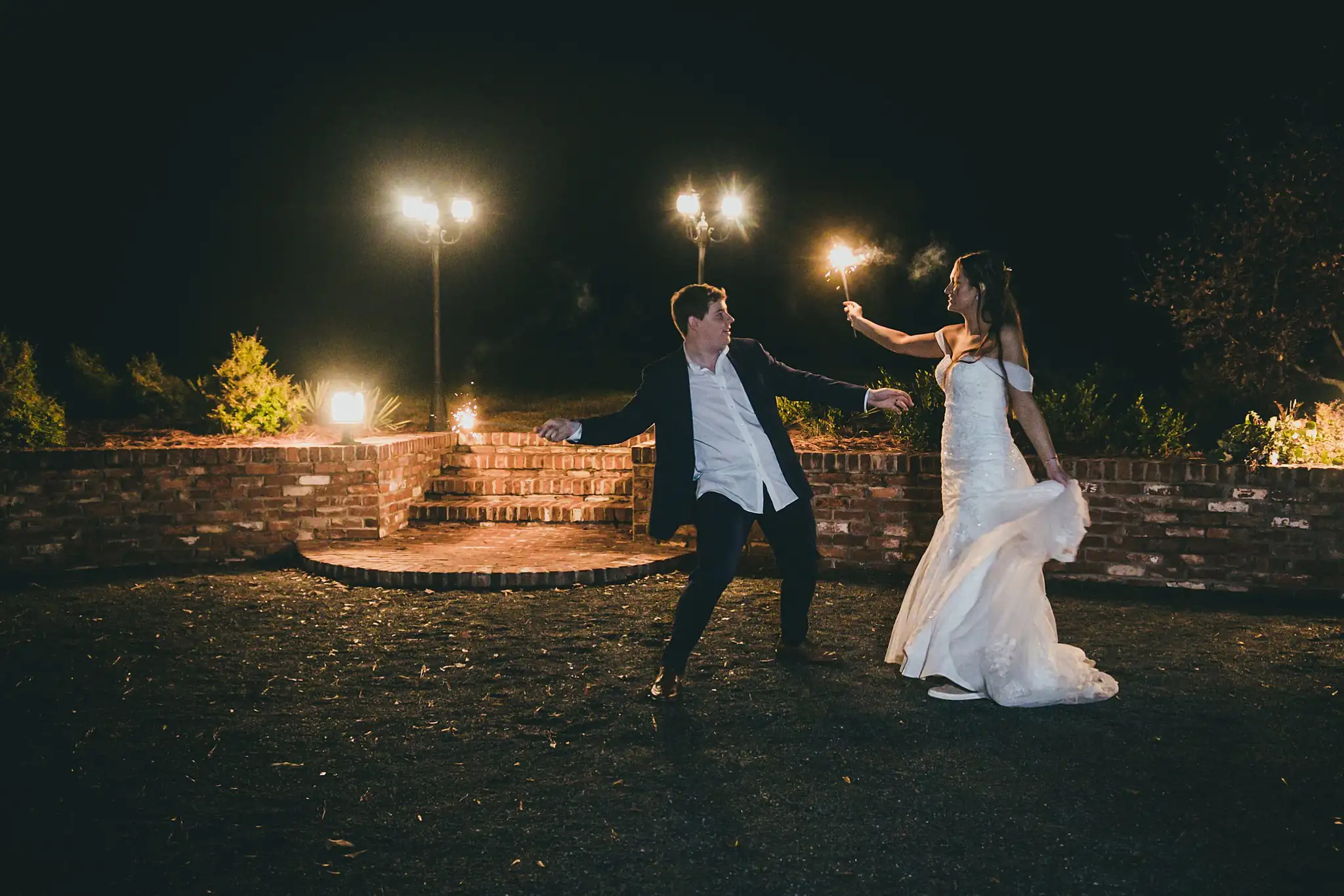 Barn at Harper Pines Wedding Thomaston, GA Atlanta Wedding Photographers Wedding Formals: the couple with sparklers after dark, at their wedding at the Barn at Harper Pines in Thomaston, GA