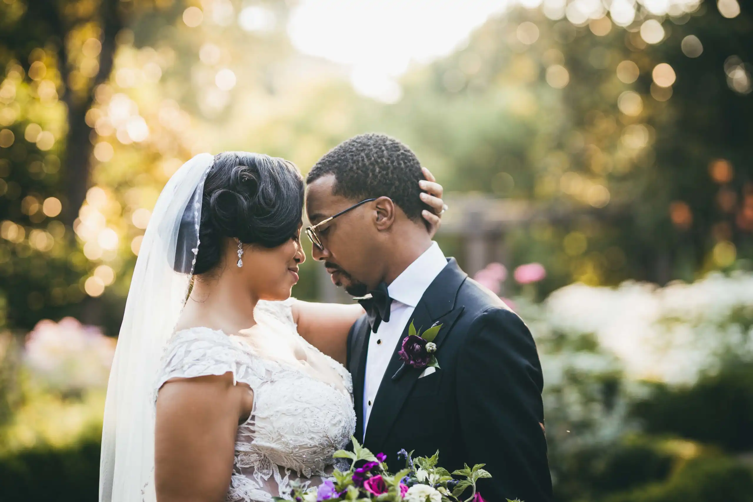 Wedding Formals: the two of them close among the flowers, her veil back, at their wedding at Callanwolde Fine Arts Center in Atlanta, GA