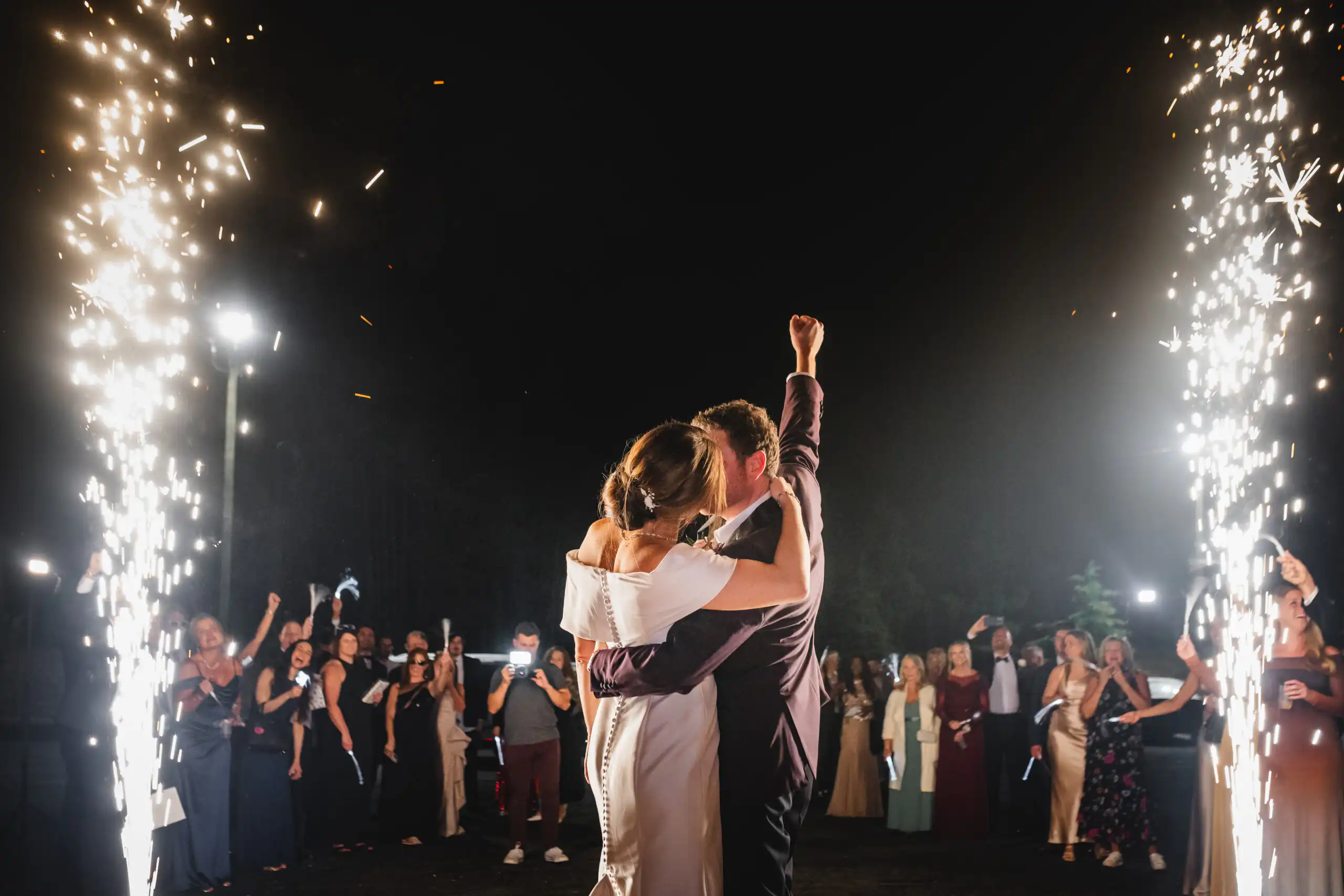 Bride and Groom leaving reception through cold sparks