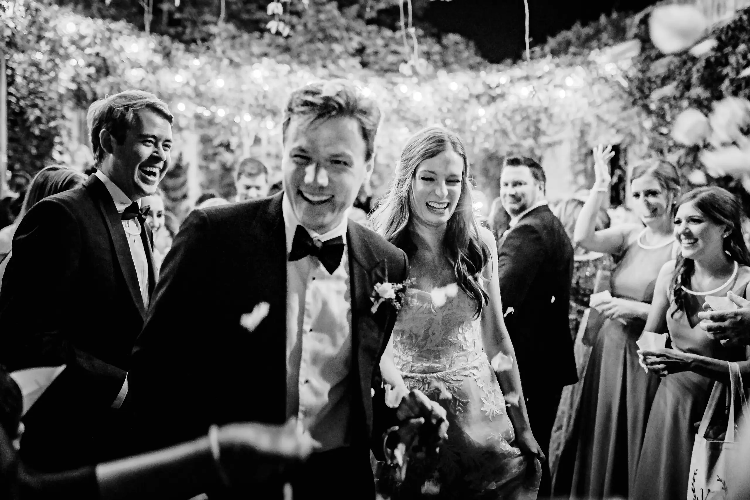 Wedding Reception: the couple moving through their guests, in black and white, at their wedding at Summerour Studio in Atlanta, GA