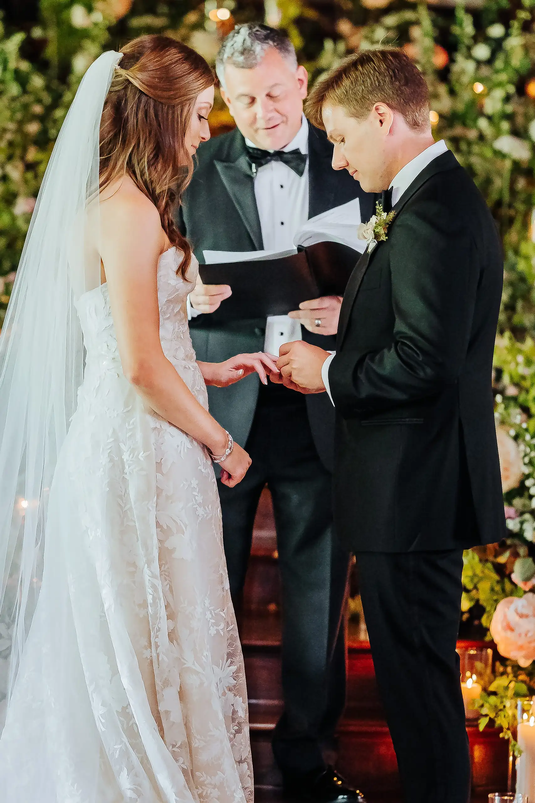 Wedding Ceremony: the officiant reading as the couple hold hands, at their wedding at Summerour Studio in Atlanta, GA