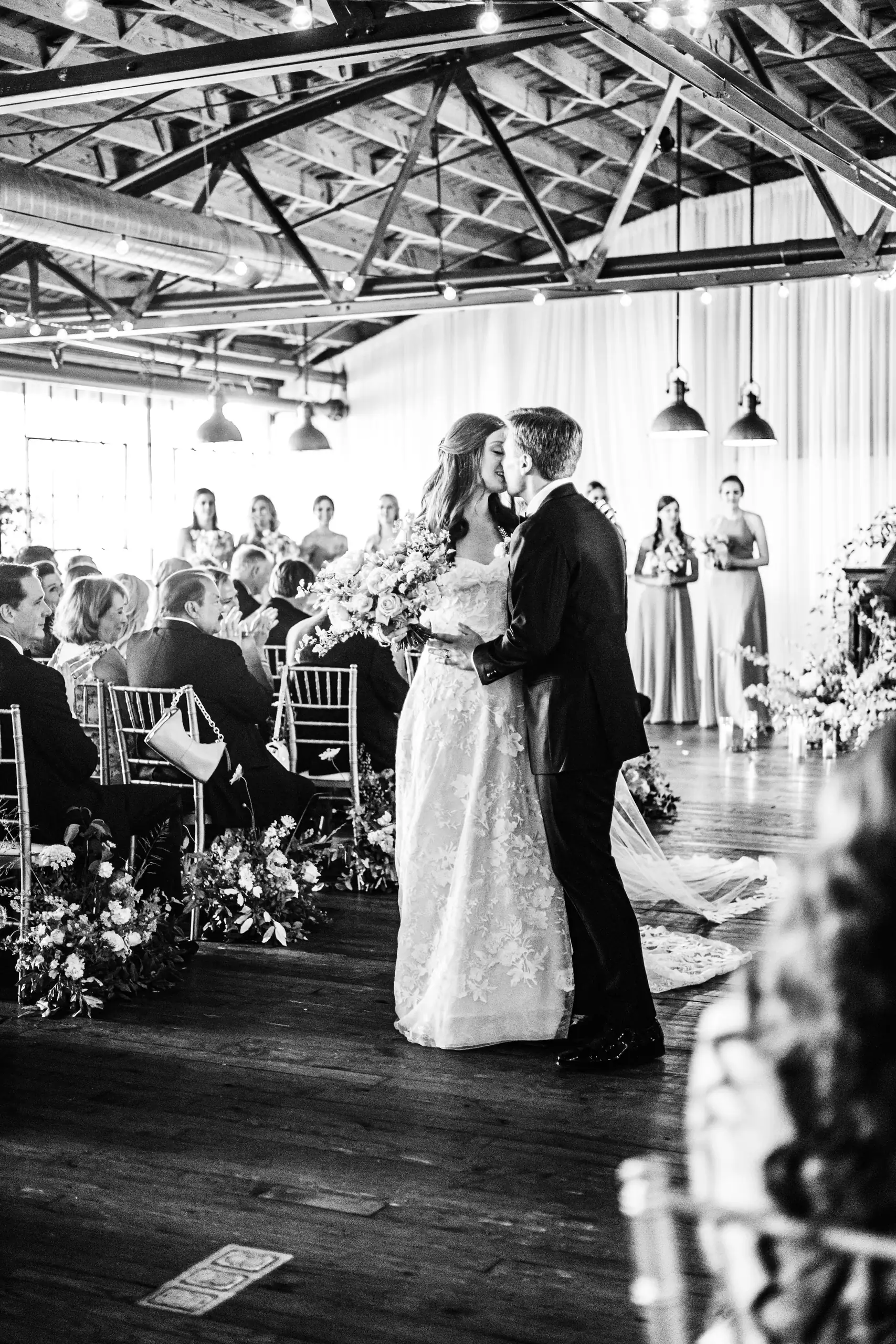 Wedding Formals: the couple kissing in the room, in black and white, at their wedding at Summerour Studio in Atlanta, GA