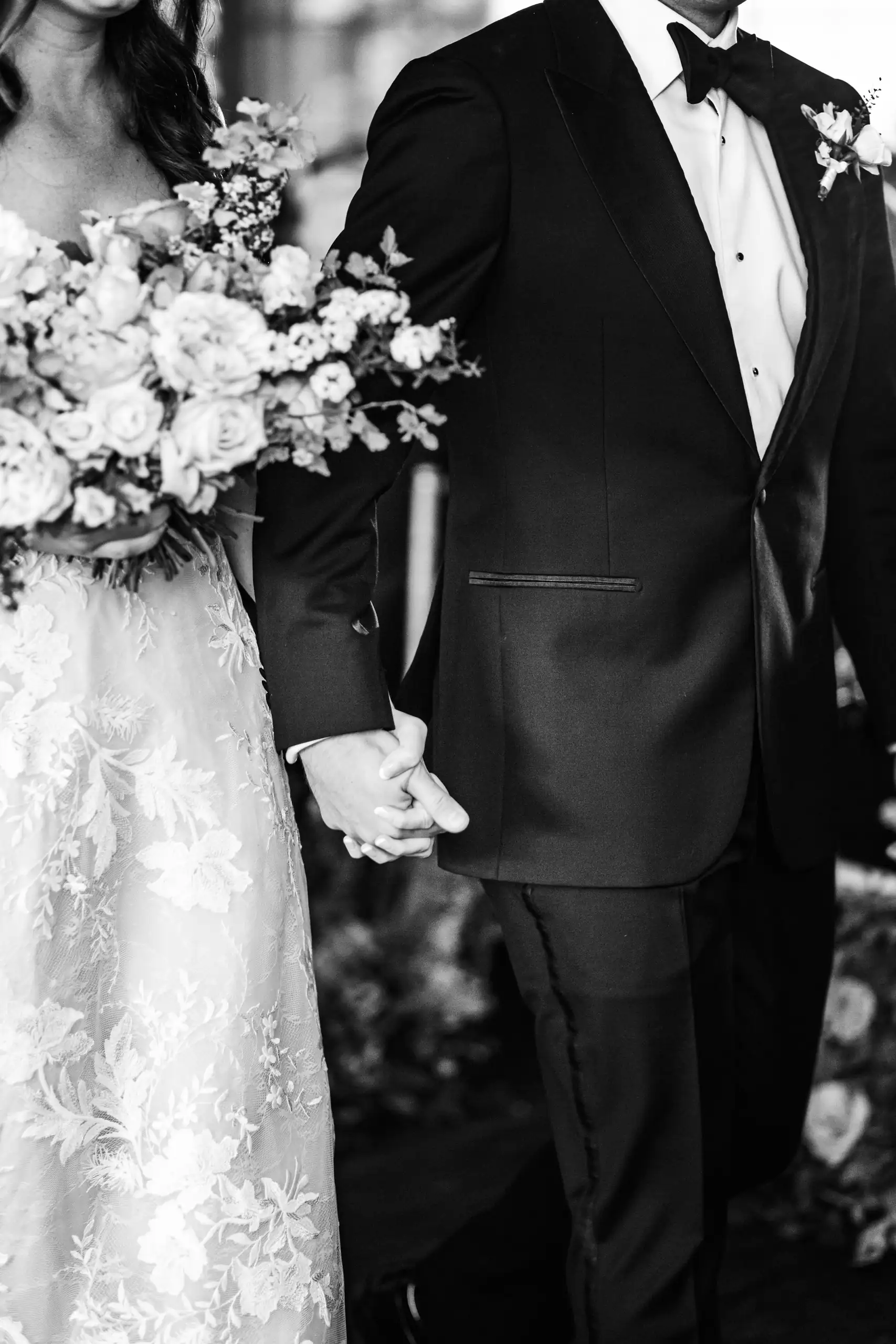 Wedding Formals: the bride's hand on the groom's arm with her bouquet, in black and white, at their wedding at Summerour Studio in Atlanta, GA