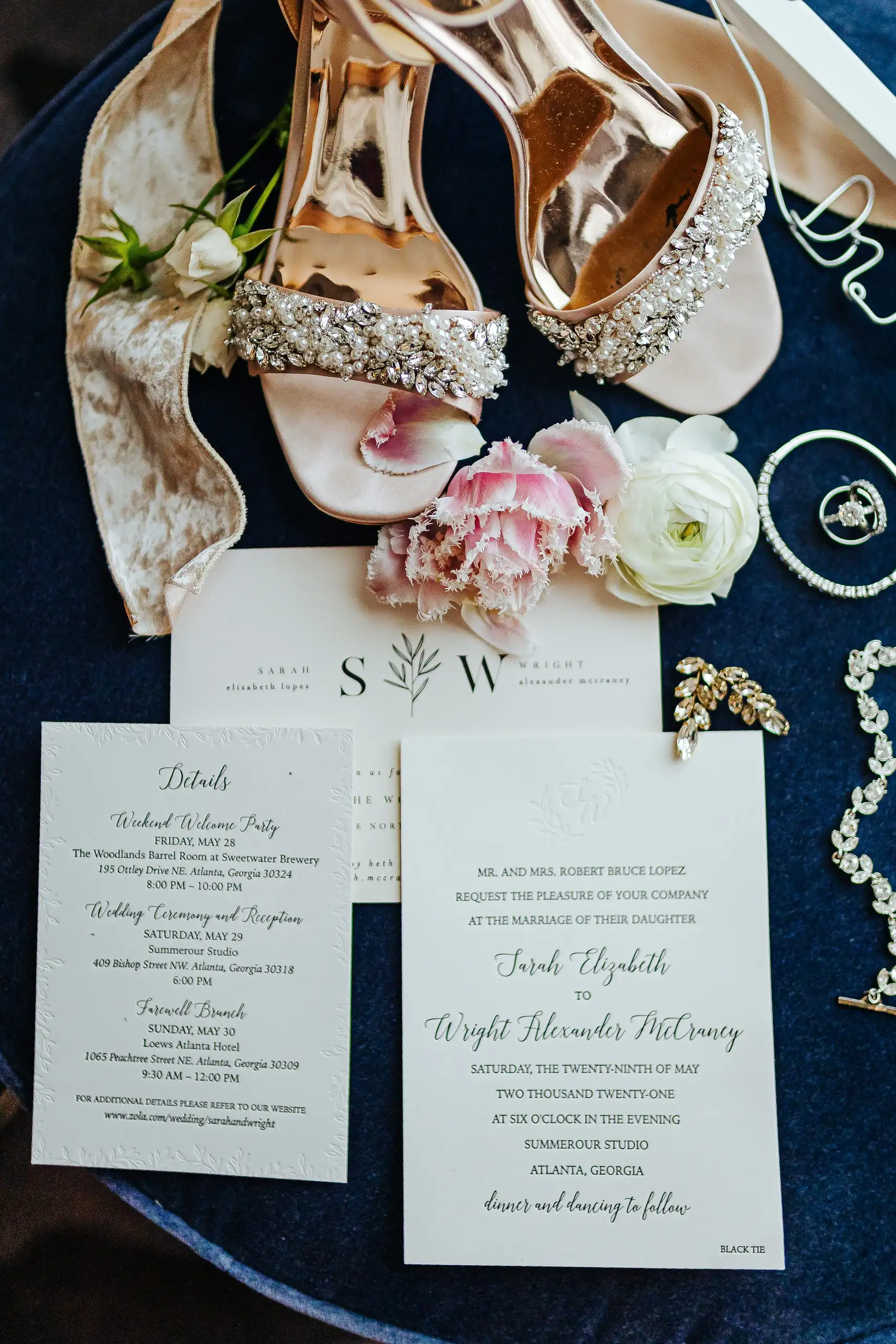 Wedding Details: the invitation suite laid out with the bride's shoes, at a wedding at Summerour Studio in Atlanta, GA