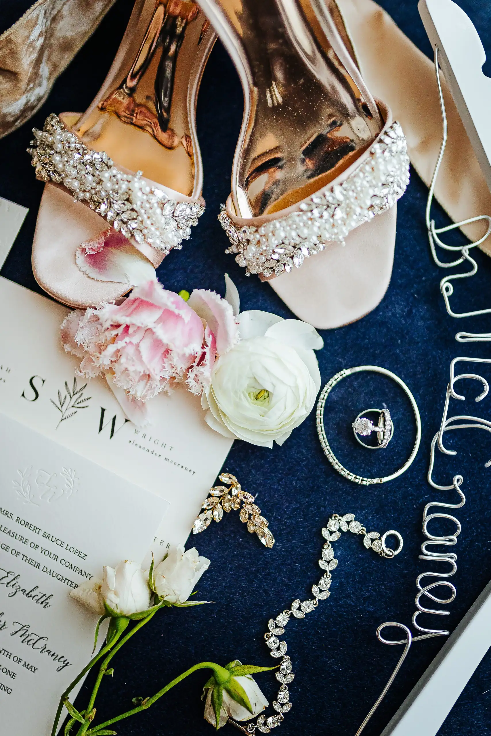 Wedding Details: the bride's jeweled shoes, rings and invitation on navy, at a wedding at Summerour Studio in Atlanta, GA