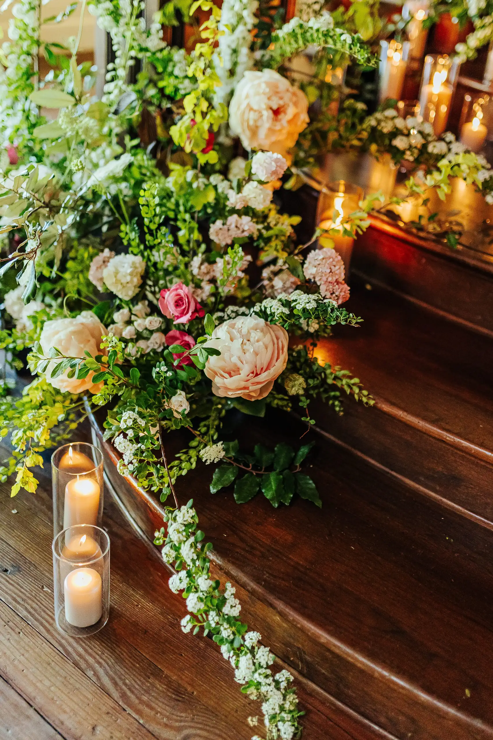 Reception Details: flowers and pillar candles down the stair treads, at a wedding at Summerour Studio in Atlanta, GA
