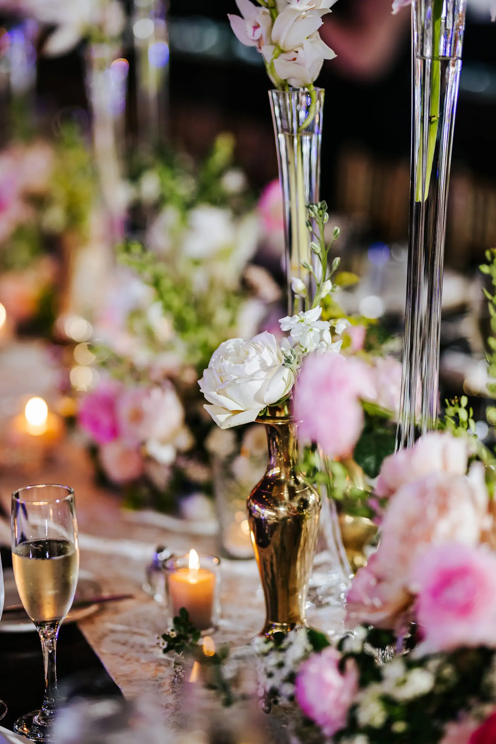 Reception Details: pink flowers and candlelight along the table, at a wedding at Summerour Studio in Atlanta, GA