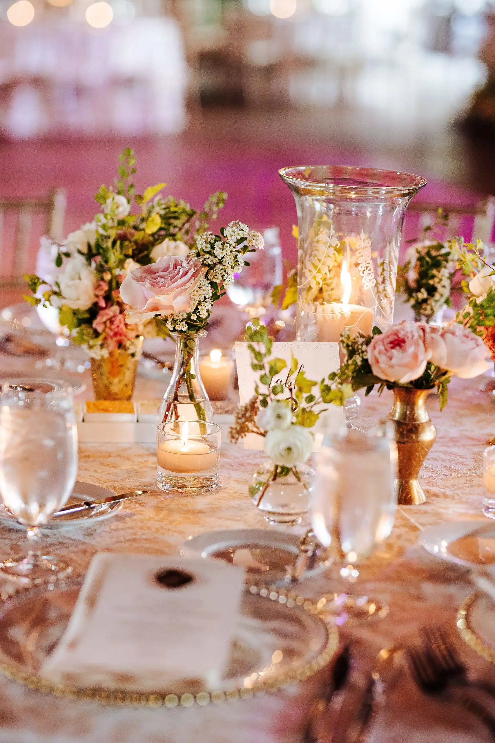 Reception Details: a place setting with bud vases and candles, at a wedding at Summerour Studio in Atlanta, GA