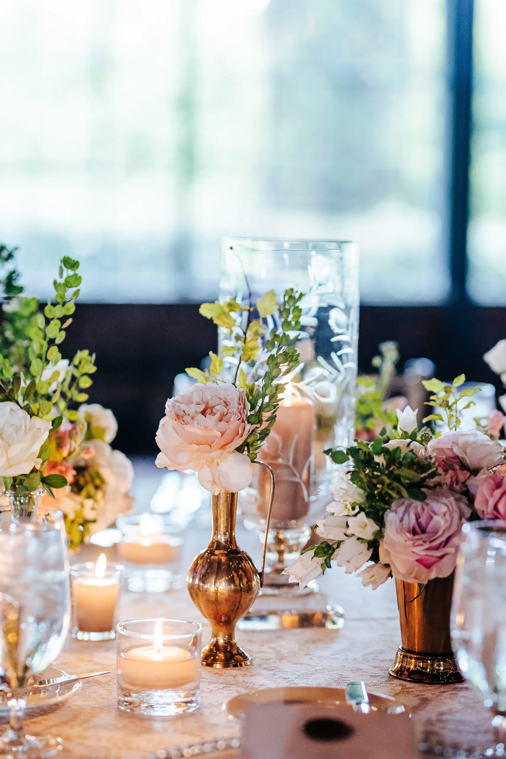 Reception Details: bud vases and votive candles on the table, at a wedding at Summerour Studio in Atlanta, GA