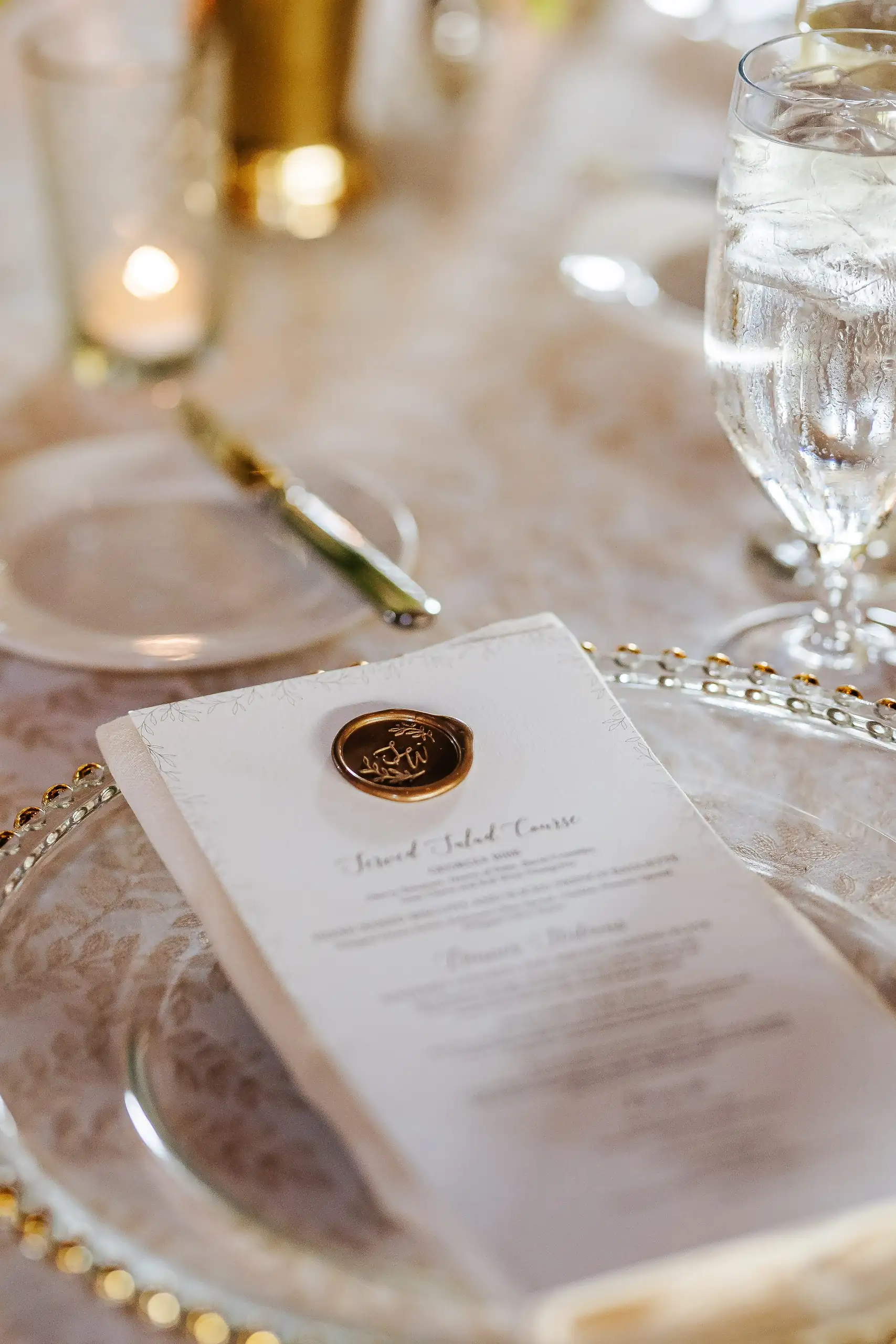 Reception Details: a menu closed with a wax seal at each place, at a wedding at Summerour Studio in Atlanta, GA