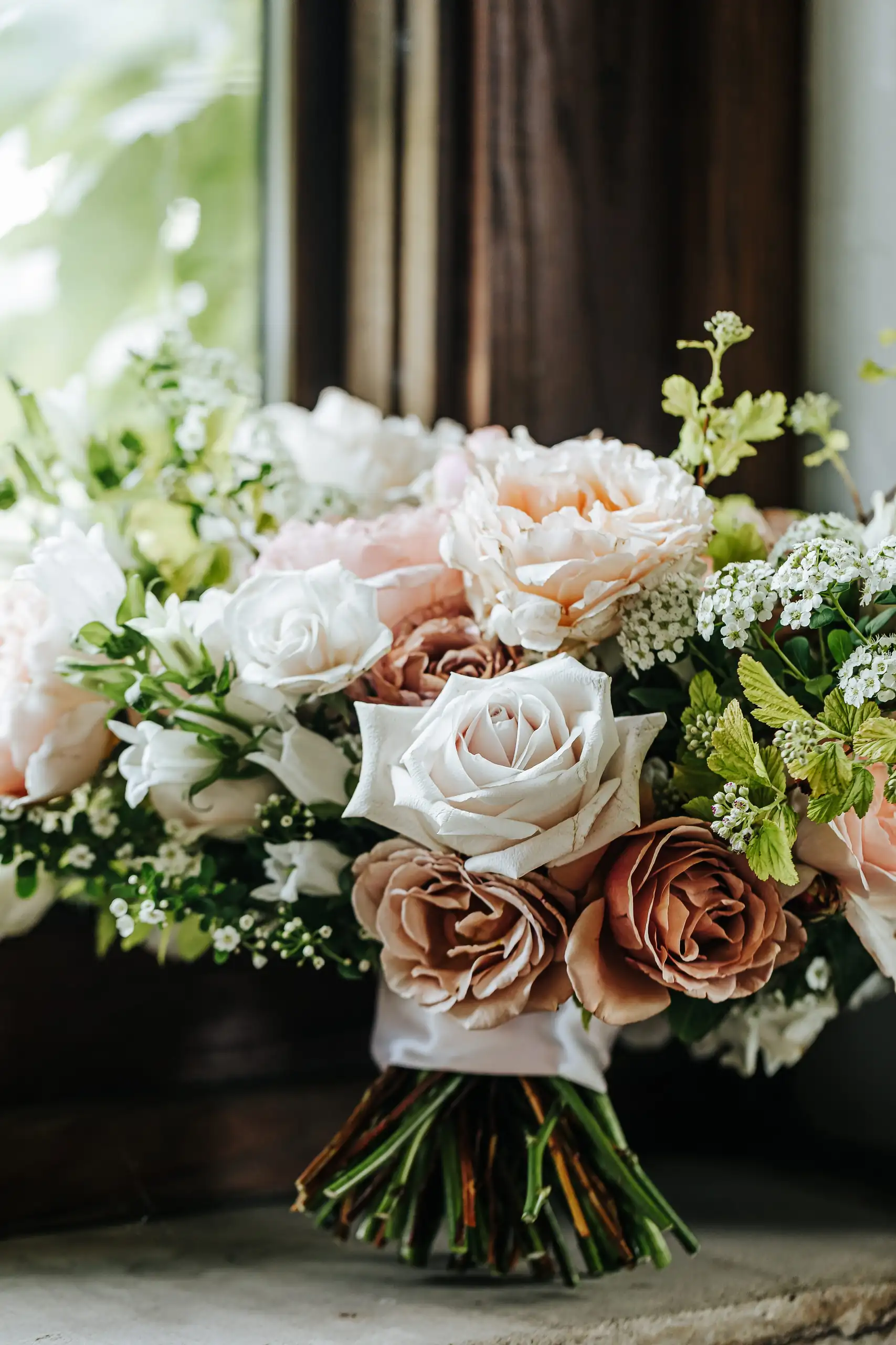 Wedding Florals: a bouquet of blush, white and toffee roses, at a wedding at Summerour Studio in Atlanta, GA